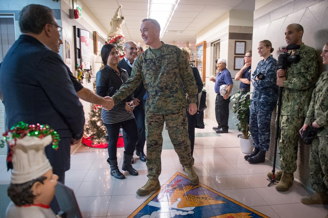 U.S. Marine Corps Gen. Joseph F. Dunford Jr., chairman of the Joint Chiefs of Staff, talks with civilians and U.S. service members on Naval Air Station Sigonella, Italy, Dec. 5, 2015. DoD photo by D. Myles Cullen