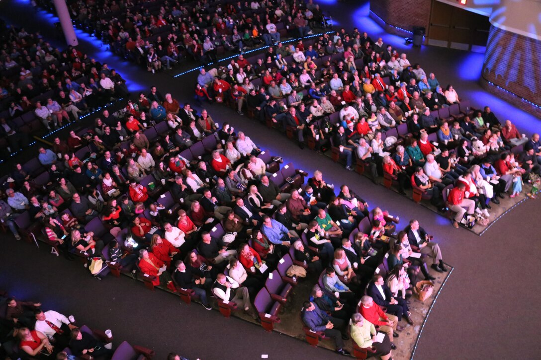Audience members watch members of the 2nd Marine Aircraft Wing band perform on stage during the annual Christmas concert at Marine Corps Air Station Cherry Point, N.C., Dec. 4, 2015. Audience members shared laughs and cheers with other members of the community while also getting the opportunity to donate to the Toys for Tots foundation. The 2nd MAW band has held the traditional concert at the air station as a way to bring both the military and local community together to unwind and share in the holiday spirit. (U.S. Marine Corps photo by Cpl. N.W. Huertas/Released)
