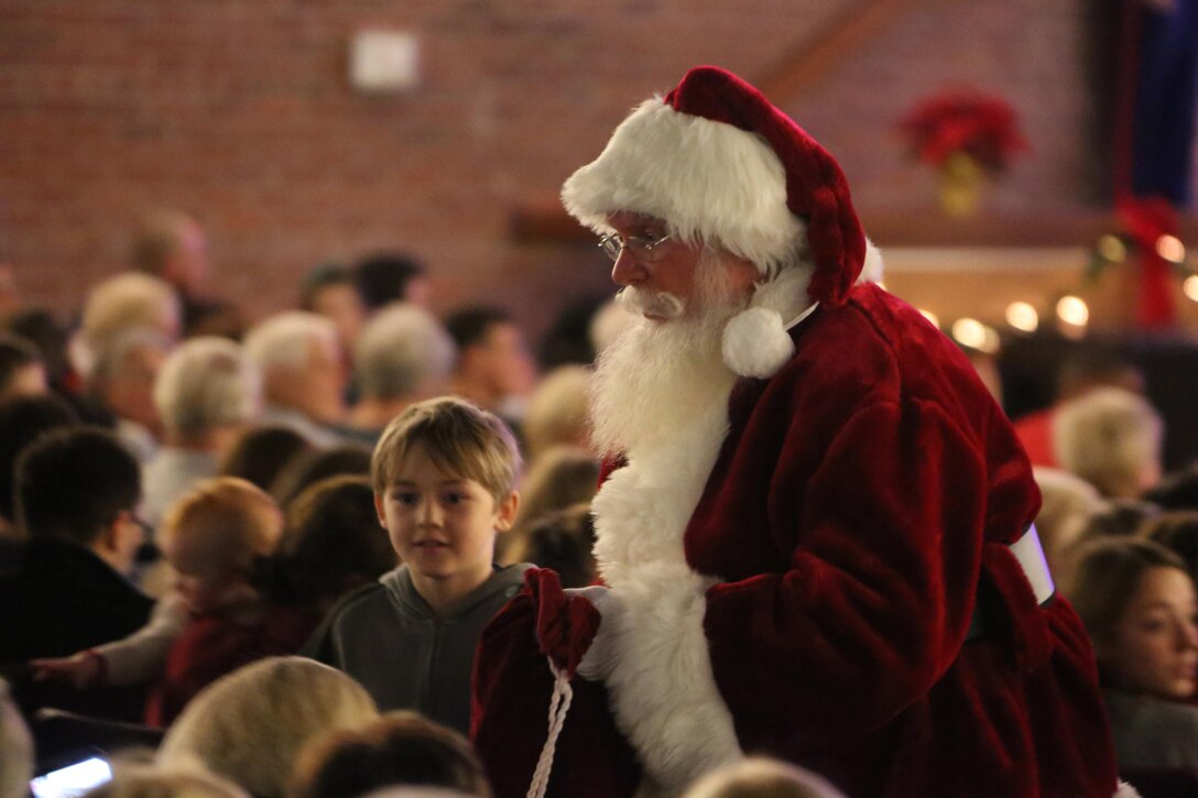 Children gather to meet Santa Claus during the annual 2nd Marine Aircraft Wing band Christmas concert at Marine Corps Air Station Cherry Point, N.C., Dec. 4, 2015. Audience members shared laughs and cheers with other members of the community while also getting the opportunity to donate to the Toys for Tots foundation. The 2nd MAW band has held the traditional concert at the air station as a way to bring both the military and local community together to unwind and share in the holiday spirit. (U.S. Marine Corps photo by Cpl. N.W. Huertas/Released)
