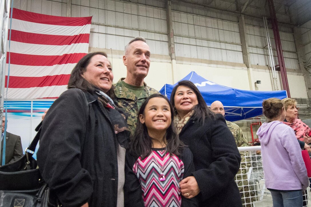 U.S. Marine Corps Gen. Joseph F. Dunford Jr., chairman of the Joint Chiefs of Staff, poses for a photo with a military family after a USO show on Naval Air Station Sigonella, Italy, Dec. 5, 2015. DoD photo by D. Myles Cullen