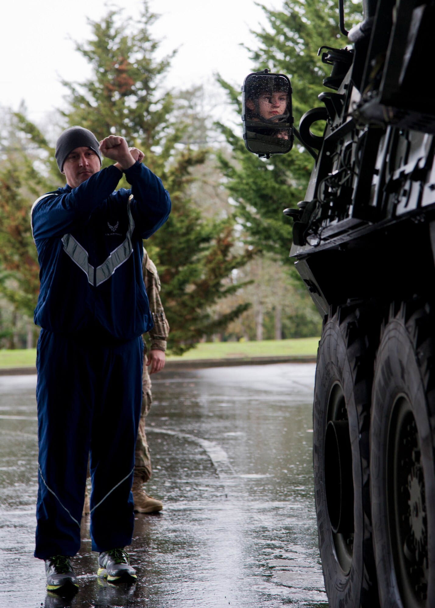 TSgt. Brett Ford, 36th Aerial Port Squadron technician, waves in an M1136 Stryker combat vehicle for measurements and weighing at Joint Base Lewis-McChord, Dec. 6. The 36th APS out of McChord Field helped to train the U.S. Army’s 301st Maneuver Enhancement Brigade on preparing a Stryker for transport in a C-17 Globemaster III. (U.S. Air Force Reserve photo by Senior Airman Daniel Liddicoet)