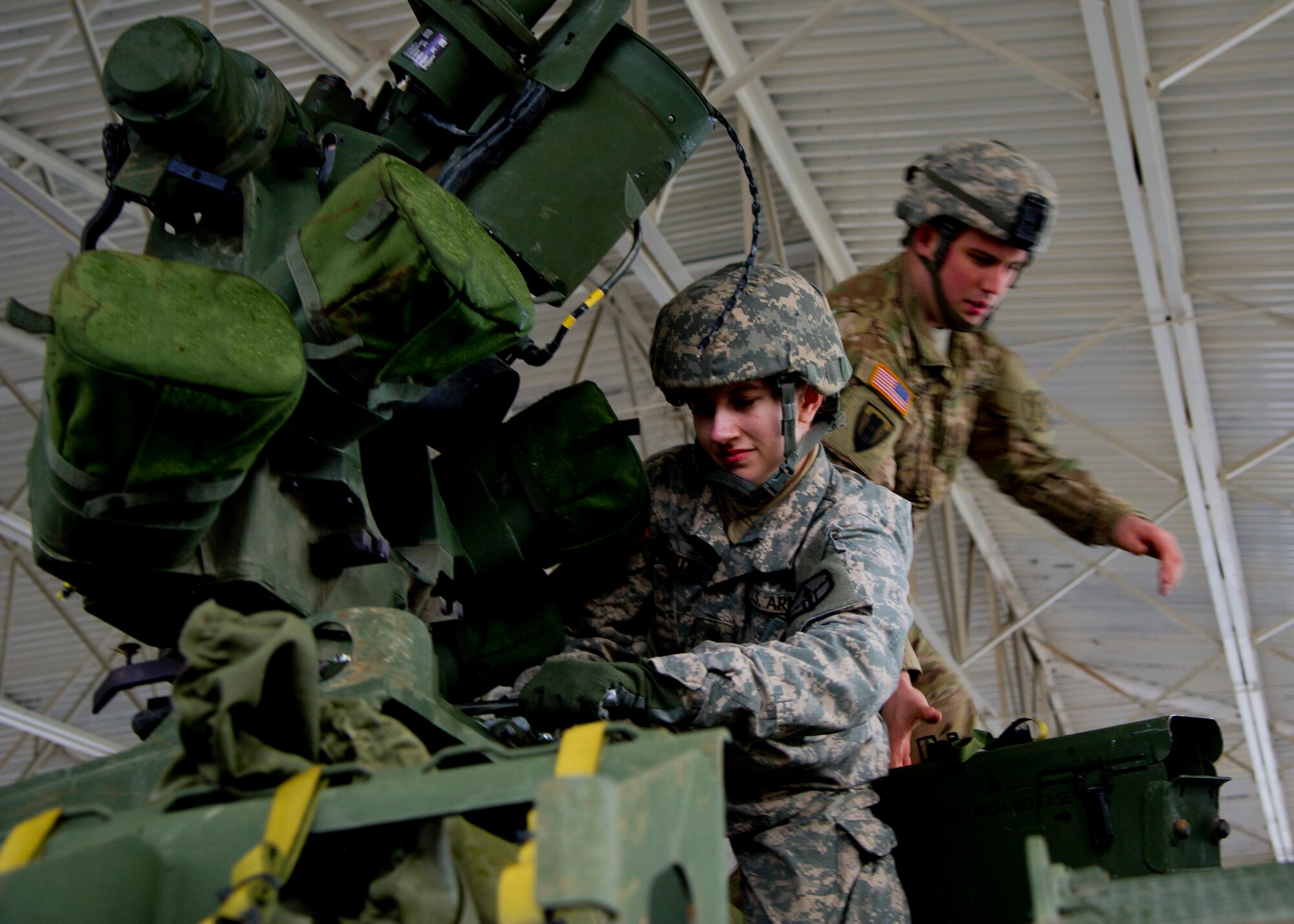 Staff Sgt. Tom Mcewan and Specialist Amanda Ballentine, 301st Maneuver Enhancement Brigade, work atop a M1136 Stryker combat vehicle to prepare it for measurements and weighing at Joint Base Lewis-McChord, Dec. 6. The 36th APS out of McChord Field helped to train the U.S. Army’s 301st Maneuver Enhancement Brigade on preparing a Stryker for transport in a C-17 Globemaster III. (U.S. Air Force Reserve photo by Senior Airman Daniel Liddicoet)