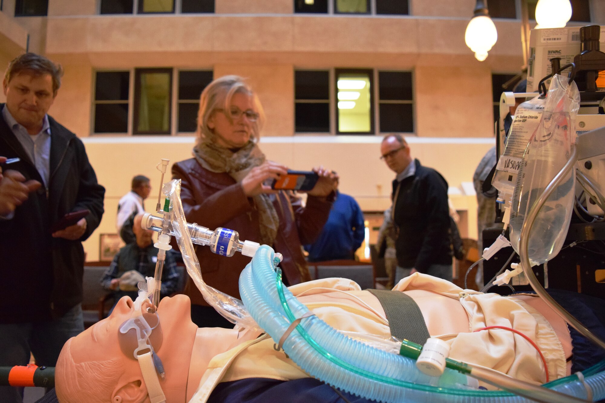 433rd Airlift Wing honorary commanders take photos and view the equipment used by the 433rd Aerospace Medicine Squadron Critical Care Air Transport Teams when transporting injured service members on Joint Base San Antonio-Lackland, Texas on Dec. 5, 2015. The honorary commanders were taking advantage of the final tour of the year for the 433rd AW where they visited the 433rd Medical Group and 433rd Operations Group. (U.S. Air Force photo/Senior Airman Bryan Swink)