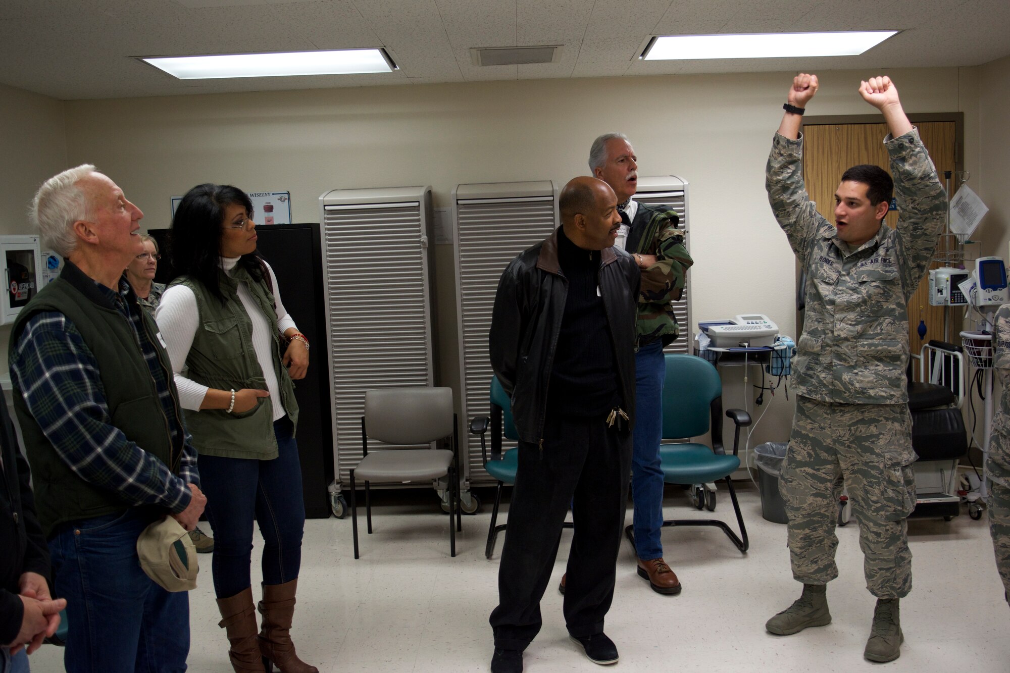 Senior Airman Gregory Flores, 433rd Medical Squadron med tech, discusses why they test for certain things during an Airmen’s physical assessment and the importance of those tests with the 433rd Airlift Wing honorary commanders here Dec. 5. The 10 honorary commanders visited numerous duty sections of Alamo Wing Airmen assigned to the 433rd Medical Group. (U.S. Air Force photo/Senior Airman Bryan Swink)