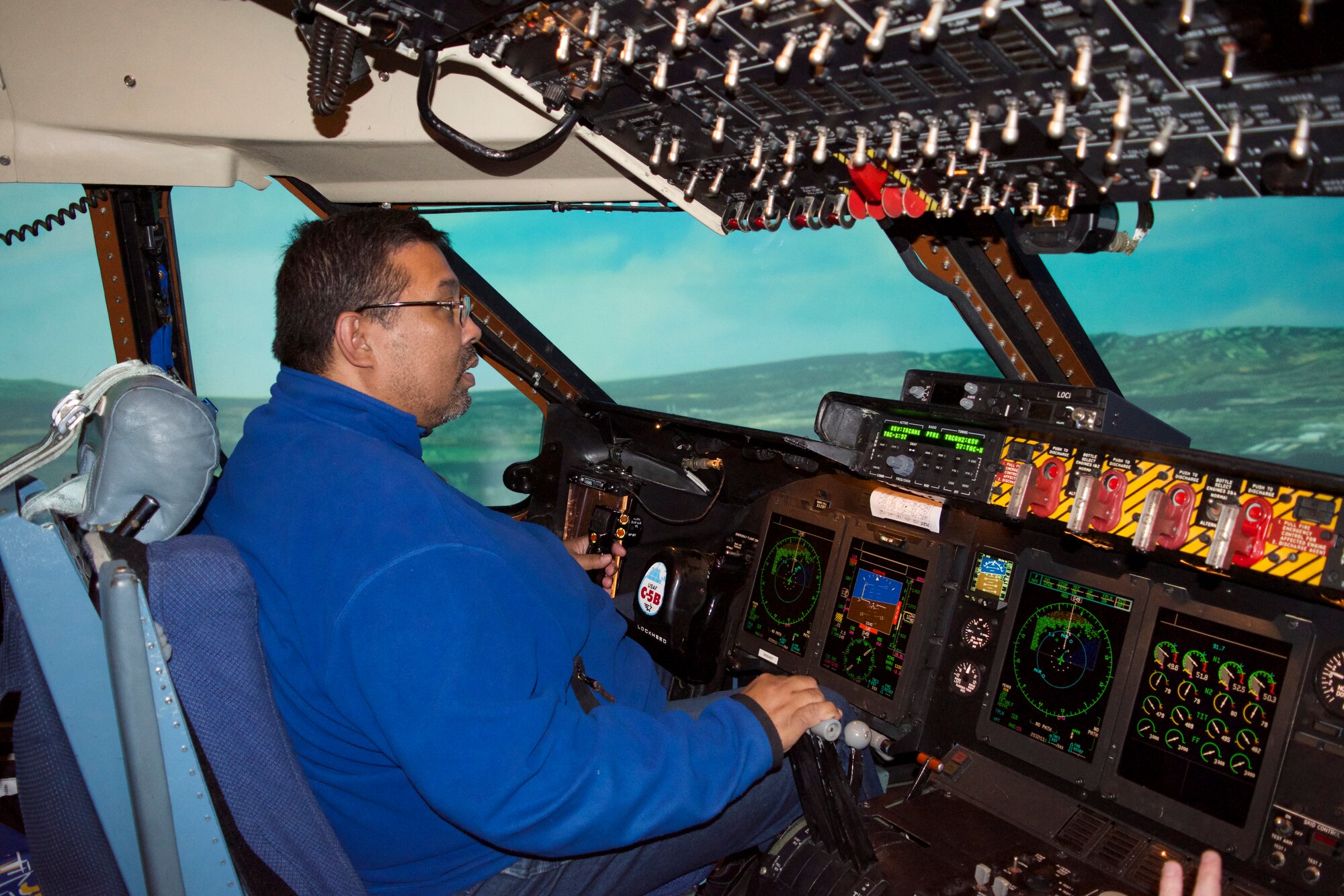 John Smith, 433rd Security Forces Squadron honorary commander and immigration officer with the Department of Homeland Security, takes the opportunity to try and take off, fly and land a C-5 Galaxy in Honolulu, Hawaii while in the simulator during the honorary commander’s tour here Dec. 5, 2015.  The simulators are designed to replicate the exact controls, movement and feeling as one would expect if actually flying in the skies. (U.S. Air Force photo/Senior Airman Bryan Swink)