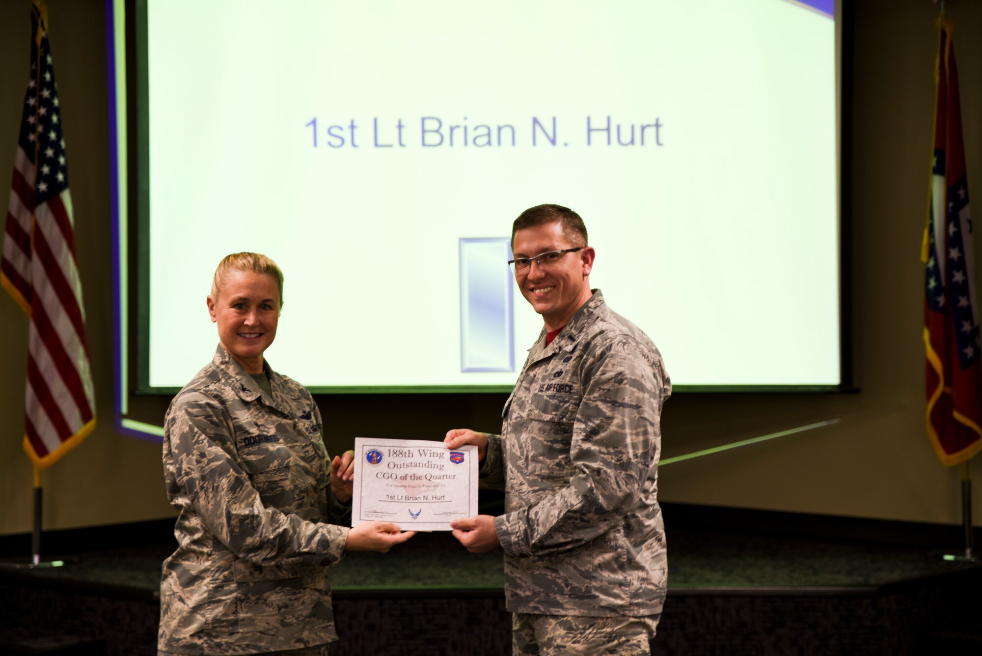 1st Lt. Brian Hurt is presented the certificate for his selection as the Company Grade Officer of the Quarter by Col. Bobbi Doorenbos, 188th Wing Commander, during a commander's call held Dec. 5, 2015. Nineteen Airmen of the Quarter nominees were recognized for their exceptional service to the wing during the last quarter that distinguished themselves among their peers in the 188th. Winners were selected in the Airman, Noncommissioned Officer, Senior NCO, Company Grade Officer and Field Grade Officer categories. (U.S. Air National Guard photo by Capt. Holli Nelson/released)
