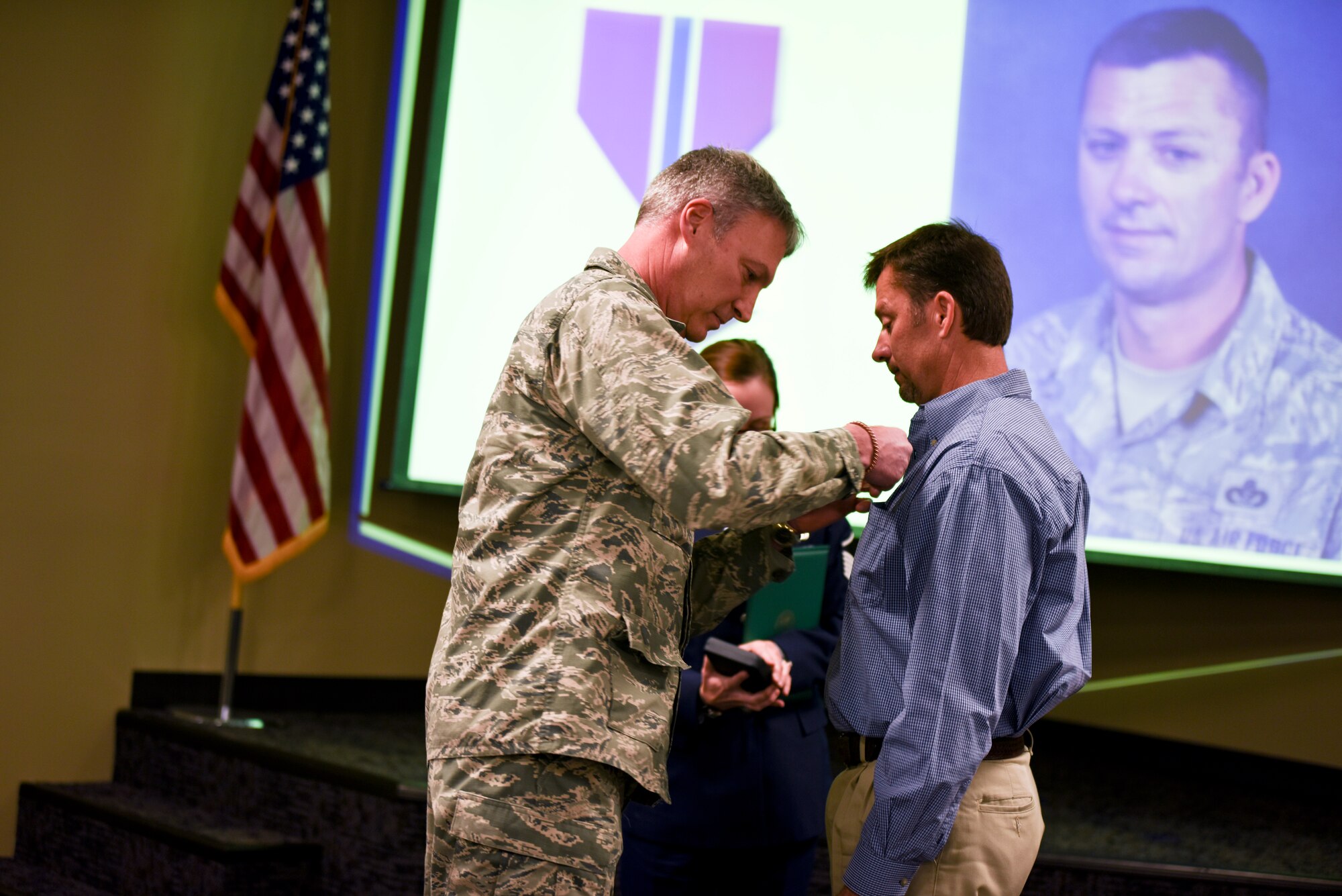 Brig. Gen. Kurt Vogel, commander of the Arkansas Air National Guard, pins a Bronze Star medal onto the shirt of former 188th member Master Sgt. Paul Fair. Fair was awarded the Bronze Star medal for his role as an Agribusiness Development Team member with the 87th Troop Command during Operation Enduring Freedom from Jan. 2010 to Jan. 2011. (U.S. Air National Guard photo by Capt. Holli Nelson/released)