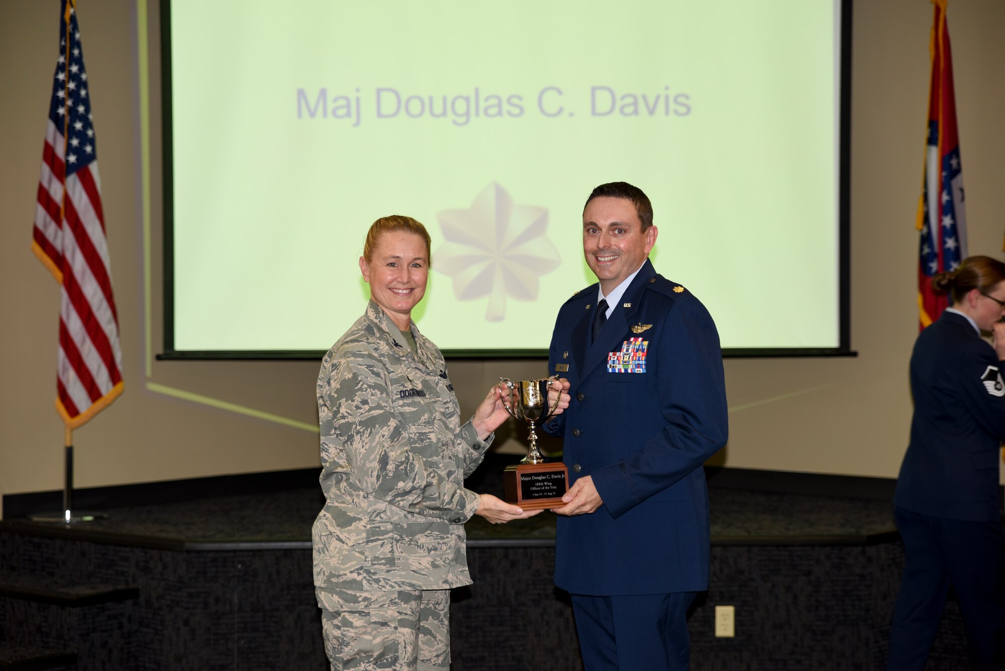 Maj. Doug Davis receives the award for Field Grade Officer of the Year  from Col. Bobbi Doorenbos, 188th Wing commander. Forty two Outstanding Airmen of the Year nominees were recognized Dec. 5, 2015 during a commander's call for their exceptional service to the wing throughout the last year that distinguished themselves among the best in the 188th. Winners were selected in the Airman, Noncommissioned Officer, Senior NCO, Company Grade Officer and Field Grade Officer categories. (U.S. Air National Guard photo by Capt. Holli Nelson/released)  