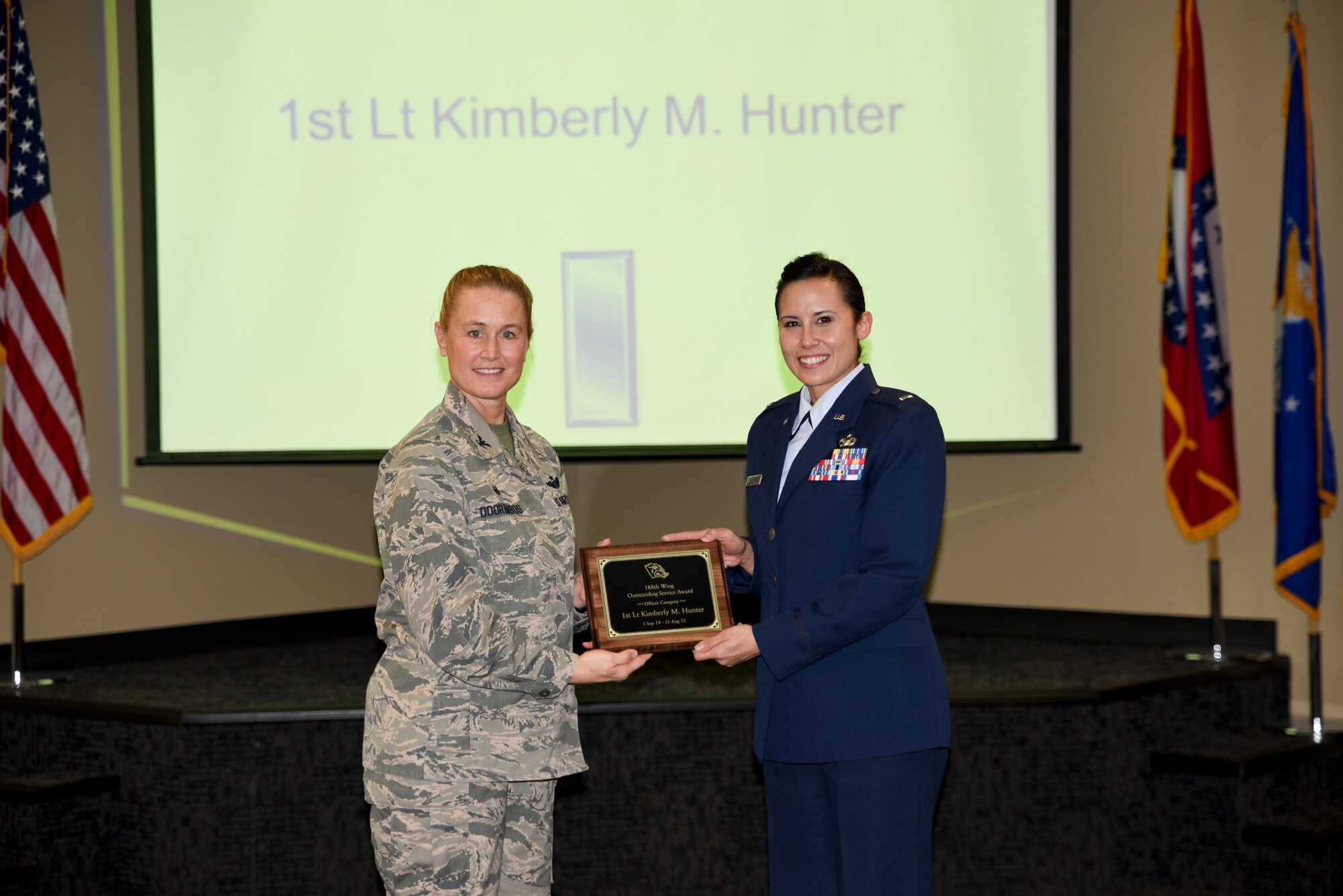 1st Lt. Kimberly Hunter receives the Outstanding Service Award from Col. Bobbi Doorenbos, 188th Wing commander, for the Company Grade Officer of the Year category. Forty two Outstanding Airmen of the Year nominees were recognized Dec. 5, 2015 during a commander's call for their exceptional service to the wing throughout the last year that distinguished themselves among the best in the 188th. Winners were selected in the Airman, Noncommissioned Officer, Senior NCO, Company Grade Officer and Field Grade Officer categories. (U.S. Air National Guard photo by Capt. Holli Nelson/released)  