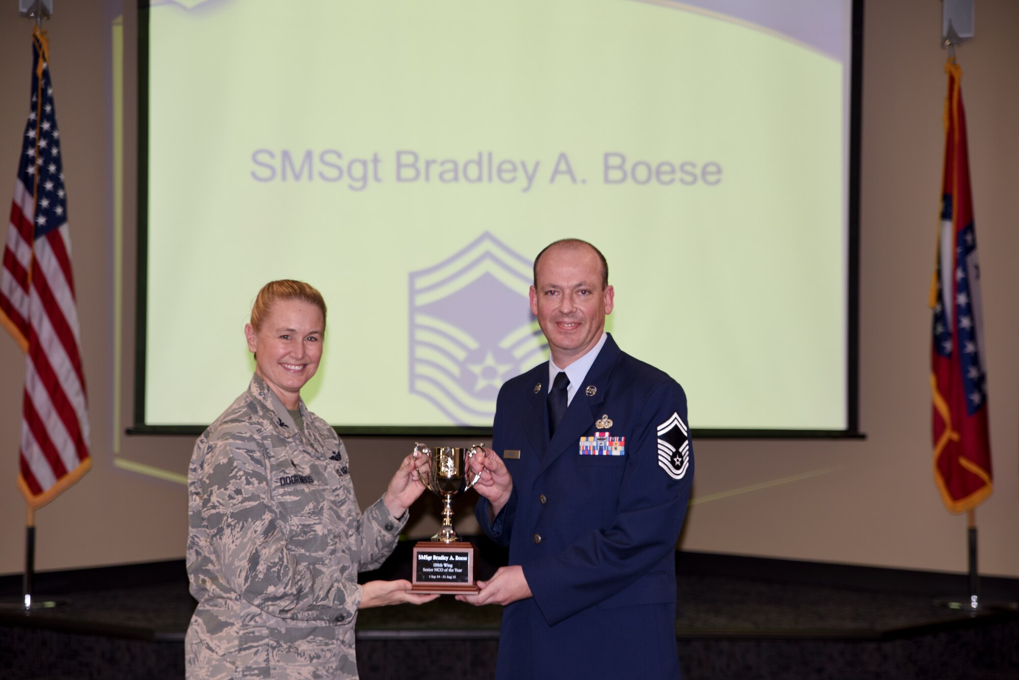 Senior Master Sgt. Bradley Boese receives the award for Outstanding Senior Noncommissioned Officer of the Year from Col. Bobbi Doorenbos, 188th Wing commander. Forty two Outstanding Airmen of the Year nominees were recognized Dec. 5, 2015 during a commander's call for their exceptional service to the wing throughout the last year that distinguished themselves among the best in the 188th. Winners were selected in the Airman, Noncommissioned Officer, Senior NCO, Company Grade Officer and Field Grade Officer categories. (U.S. Air National Guard photo by Capt. Holli Nelson/released)  