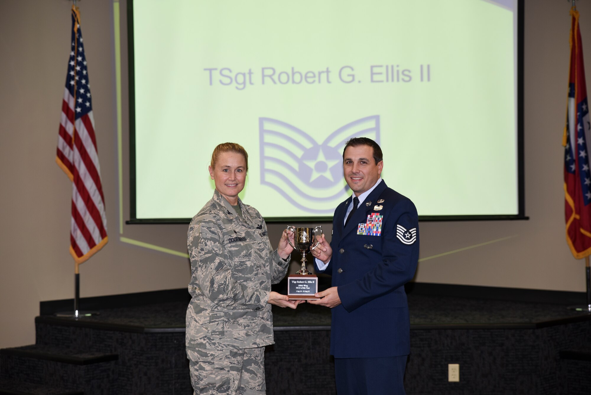 Tech. Sgt. Robert Ellis receives the award for Outstanding Noncommissioned Officer of the Year from Col. Bobbi Doorenbos, 188th Wing commander. Forty two Outstanding Airmen of the Year nominees were recognized Dec. 5, 2015 during a commander's call for their exceptional service to the wing throughout the last year that distinguished themselves among the best in the 188th. Winners were selected in the Airman, Noncommissioned Officer, Senior NCO, Company Grade Officer and Field Grade Officer categories. (U.S. Air National Guard photo by Capt. Holli Nelson/released)  