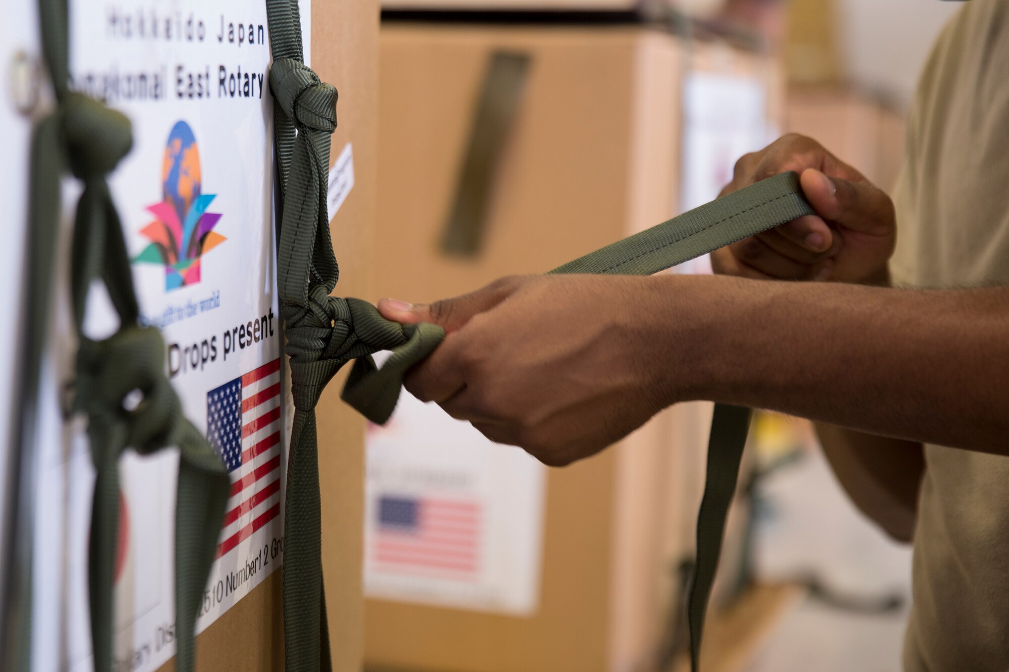 A rigger from the 374th Logistics Readiness Squadron builds a low-cost, low-altitude bundle destined for Micronesia during Operation Christmas Drop at Andersen Air Force Base, Guam, Dec. 5, 2015. Operation Christmas Drop is a humanitarian aid/disaster relief training event where C-130 aircrews perform LCLA airdrops on unsurveyed drop zones while providing critical supplies to 56 islands throughout the Commonwealth of the Northern Marianas, Federated States of Micronesia and Republic of Palau. It highlights the U.S. and allied airpower capabilities to orient and respond to activities in peacetime and crisis. In addition to delivering critical supplies to those in need, Operation Christmas Drop provides specific training to U.S. and allied aircrews, enabling theater-wide airpower. (U.S. Air Force photo by Osakabe Yasuo/Released)
