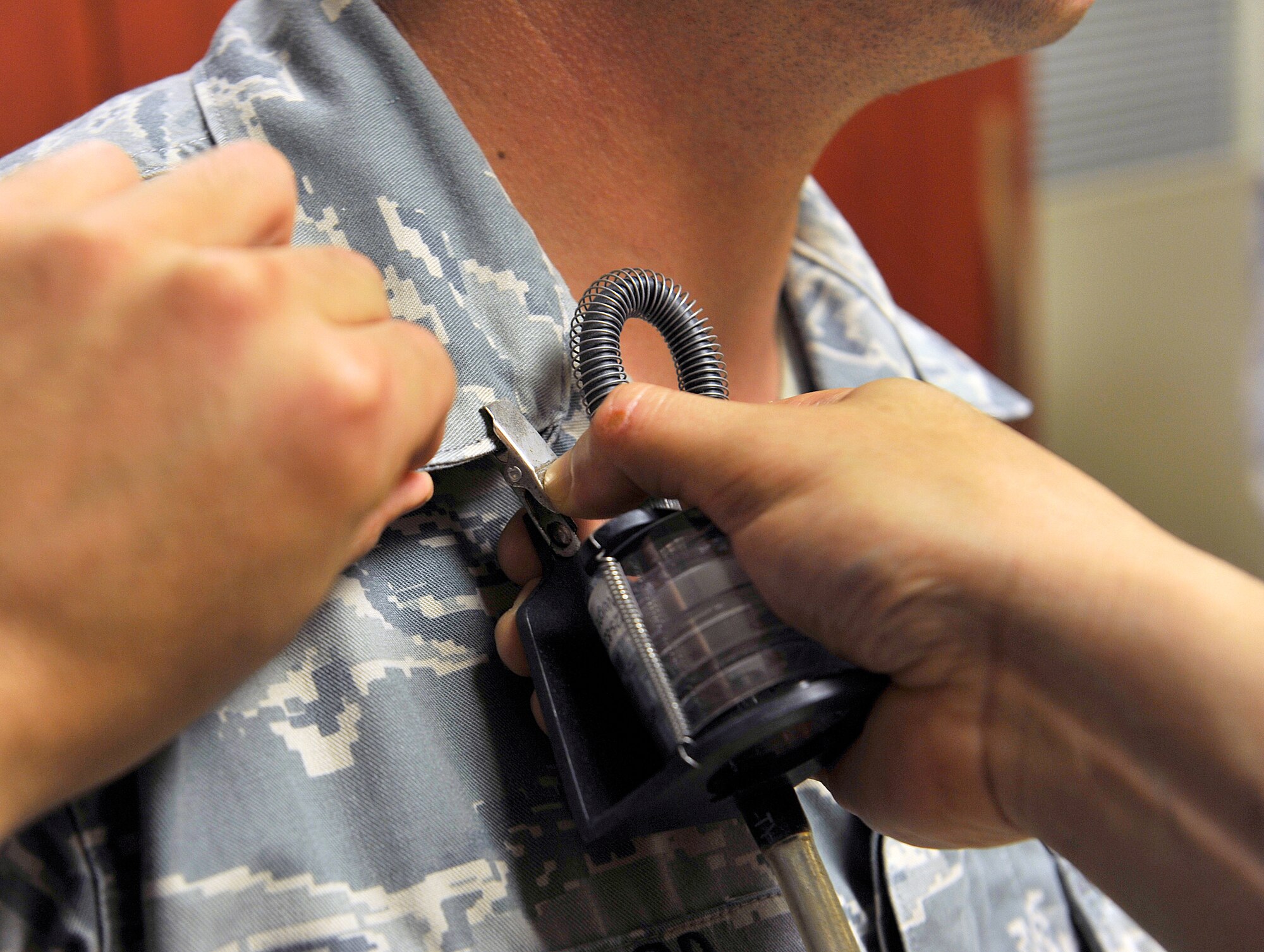 U.S. Air Force Senior Airman Gerardo Salas, 18th Aerospace Medicine Squadron bioenvironmental engineering journeyman, helps Staff Sgt. Jeffery Peppeard, 18th Security Forces Squadron combat arms instructor, attach an air sampling pump at the combat arms training maintenance range, Dec. 3, 2015, at Kadena Air Base, Japan. The air sampling survey is important to ensure Airmen are always safe from health hazards. (U.S. Air Force photo by Naoto Anazawa) 

