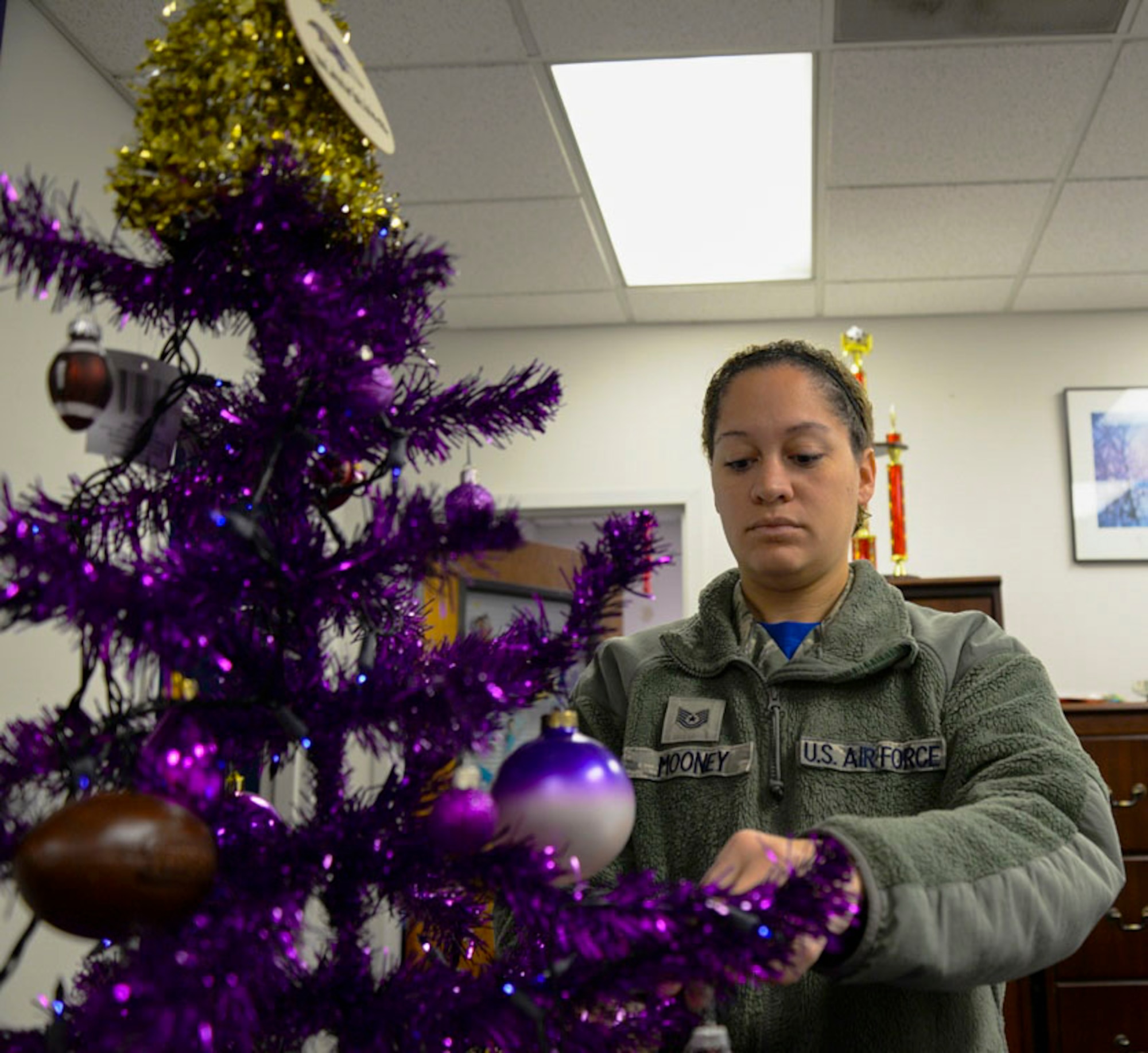 Tech. Sgt. Ashley Mooney, 175th Logistics Readiness Squadron unit training manager decorates a tree with gifts for families in need Dec. 5, 2015 at Warfield Air National Guard Base, Baltimore, Md. Mooney was recognized for her continuing work with the Salvation Army Angel Tree Program since 2012.(U.S. Air National Guard photo by Airman 1st Class Enjoli Saunders/RELEASED)
