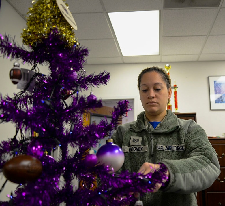 Tech. Sgt. Ashley Mooney, 175th Logistics Readiness Squadron unit training manager decorates a tree with gifts for families in need Dec. 5, 2015 at Warfield Air National Guard Base, Baltimore, Md. Mooney was recognized for her continuing work with the Salvation Army Angel Tree Program since 2012.(U.S. Air National Guard photo by Airman 1st Class Enjoli Saunders/RELEASED)
