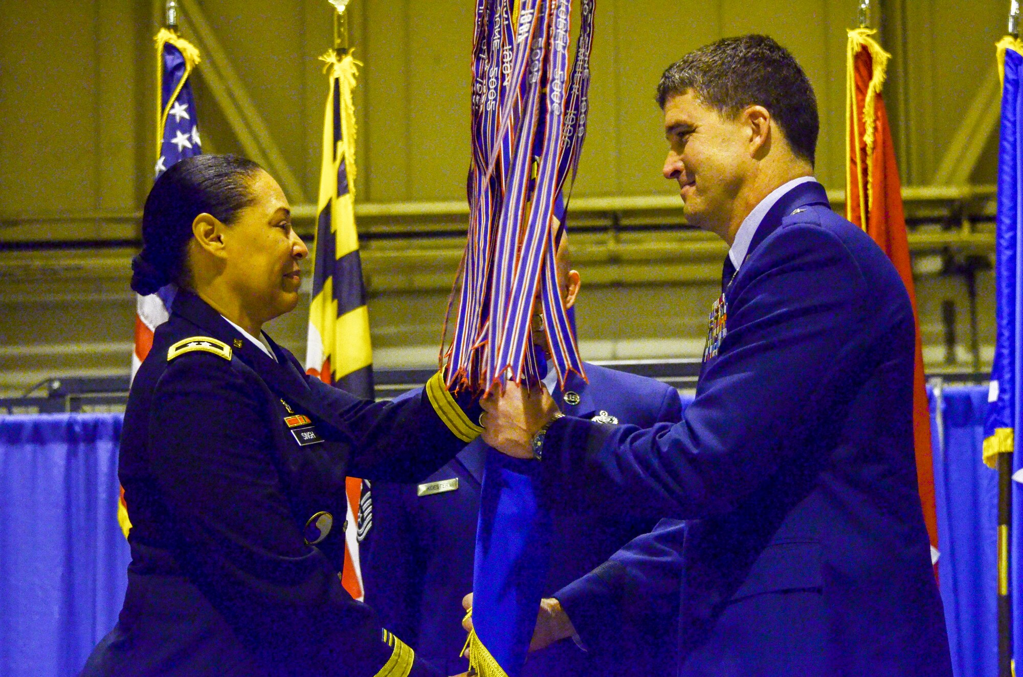 U.S Air Force Brig. Gen. Randolph Staudenraus, 175th Wing Commander, accepts the guidon from U.S. Army Maj. Gen. Linda Singh, Maryland National Guard Adjutant General at Warfield Air National Guard Base, Baltimore, Md., during a change of command ceremony December 6, 2015. During the ceremony Brig. Gen. Randolph Staudenraus assumed command of the 175th Wing from Brig. Gen. Scott L. Kelly.(U.S. Air National Guard photo by Tech. Sgt. David Speicher/RELEASED) 