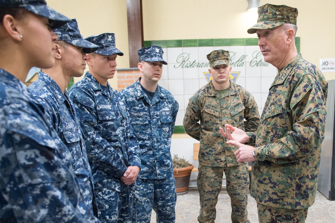 U.S. Marine Corps Gen. Joseph F. Dunford Jr., chairman of the Joint Chiefs of Staff, talks with U.S. sailors on Naval Air Station Sigonella, Italy, Dec. 5, 2015. Dunford is traveling with entertainers to visit deployed U.S. service members during the 2015 USO Holiday Tour. DoD photo by D. Myles Cullen