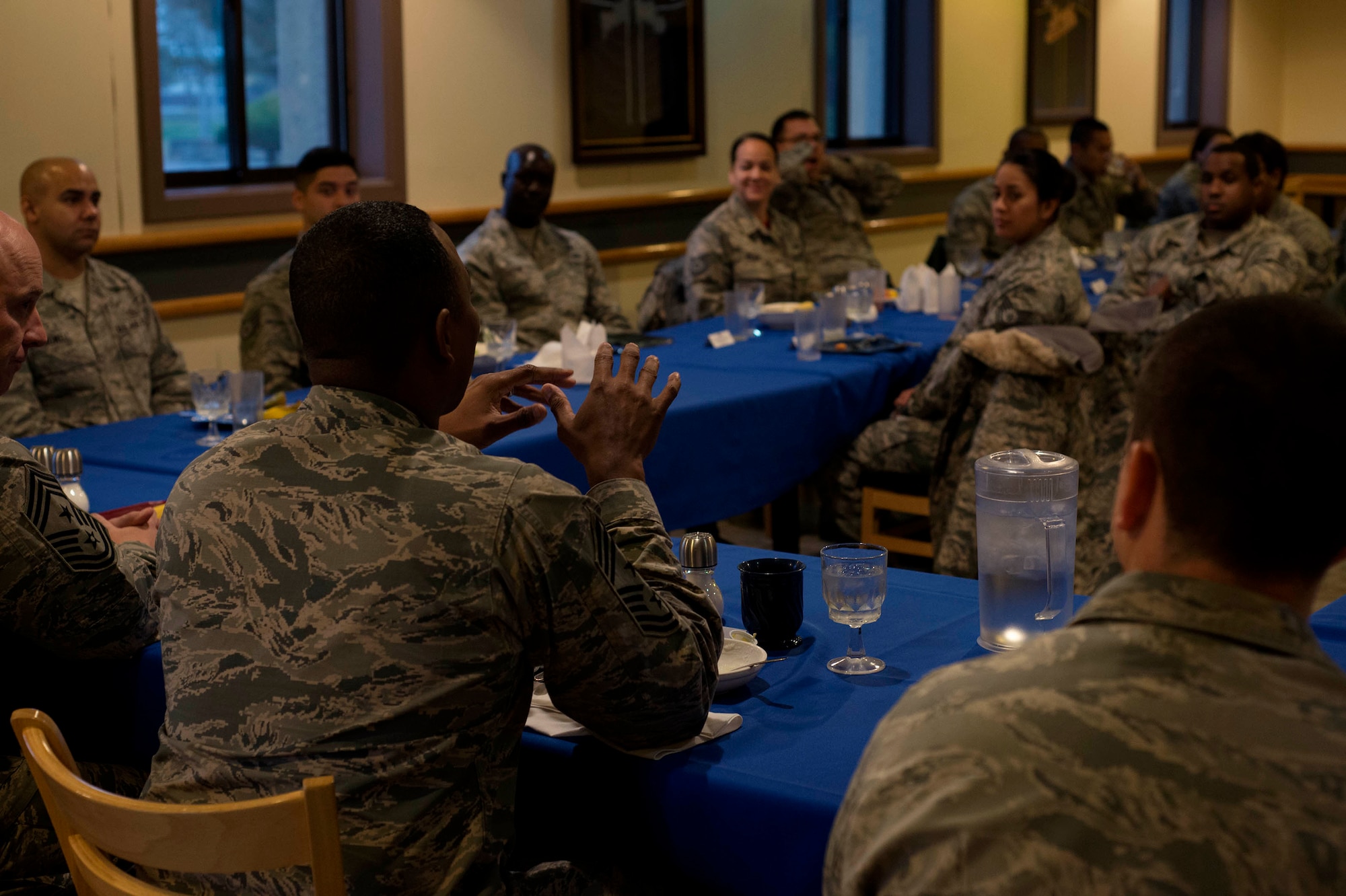 Chief Master Sgt. Anthony Johnson, Seventh Air Force command chief, has an early morning breakfast with several military members during his immersion tour at Kunsan Air Base, Republic of Korea, Dec. 4, 2015. In addition to the information on where and how Kunsan performs day-to-day, leadership gained knowledge on the tough jobs Airmen perform. (U.S. Air Force photo by Senior Airman Ashley L. Gardner/Released)