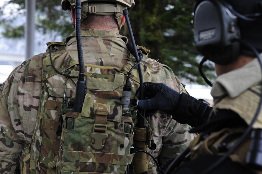 Senior Airman William Irvin, 604th Air Support Operations Squadron joint terminal air controller, helps set up radio communication equipment for 1st Lt. Austin Hairfield, 604th ASOS tactical air control party officer in charge, during Exercise Woody Cloud 16-1, Dec. 4, 2015. Exercise Woody Cloud 16-1 was the first-ever exercise that allowed pilots and JTAC Airmen to train side by side. (U.S. Air Force photo by Staff Sgt. Nick Wilson/Released)