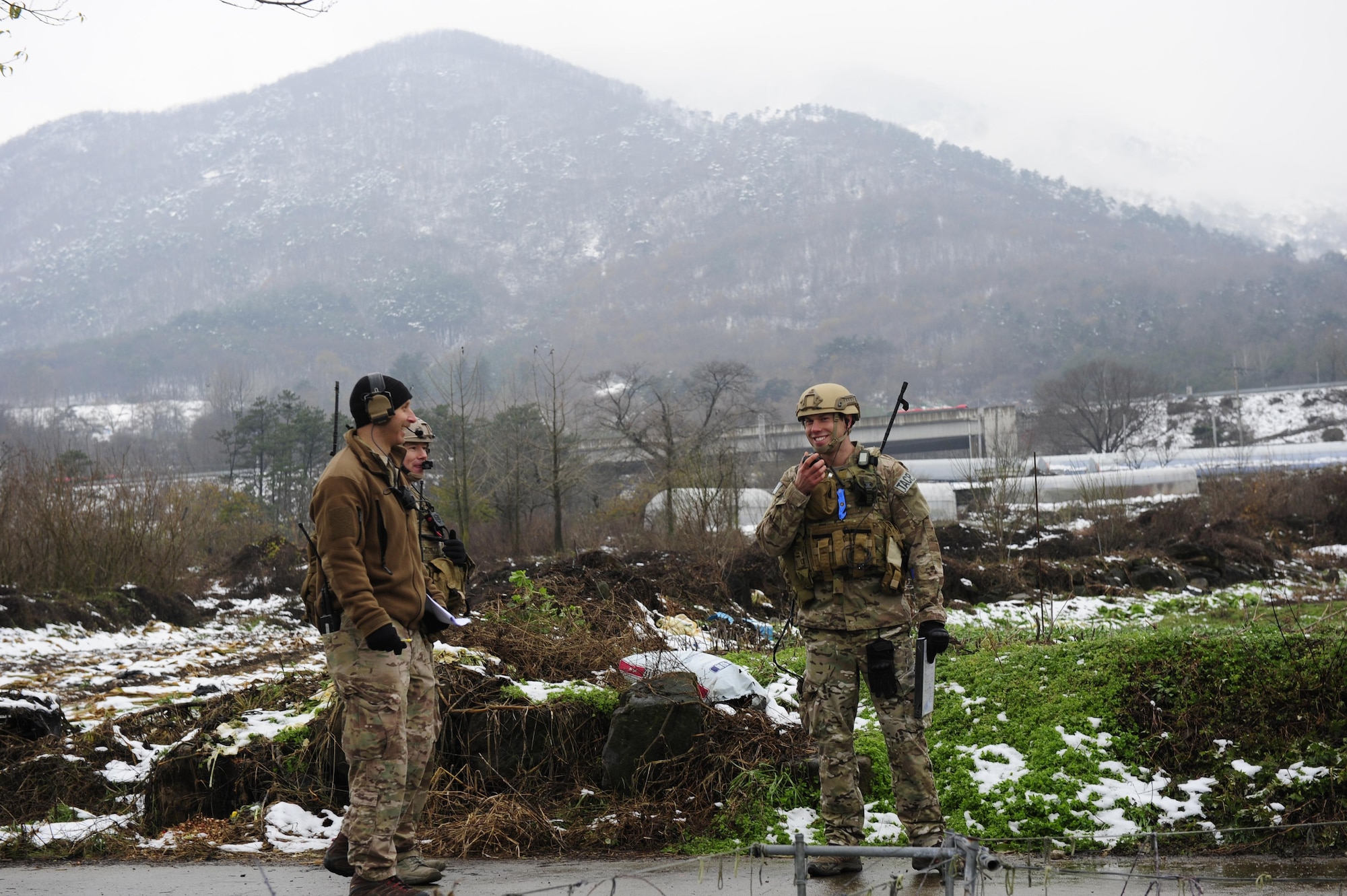 Staff Sgt. Stephen Stein, Tech. Sgt. Patrick Naughton and 1st. Lt. Austin Hairfield, all 604th Air Support Operations Squadron tactical air control party members, share a laugh during Exercise Woody Cloud 16-1, Dec. 4, 2015. The first-ever exercise simulated scenarios of events JTAC Airmen experienced during previous tours in Iraq and Afghanistan. (U.S. Air Force photo by Staff Sgt. Nick Wilson/Released)