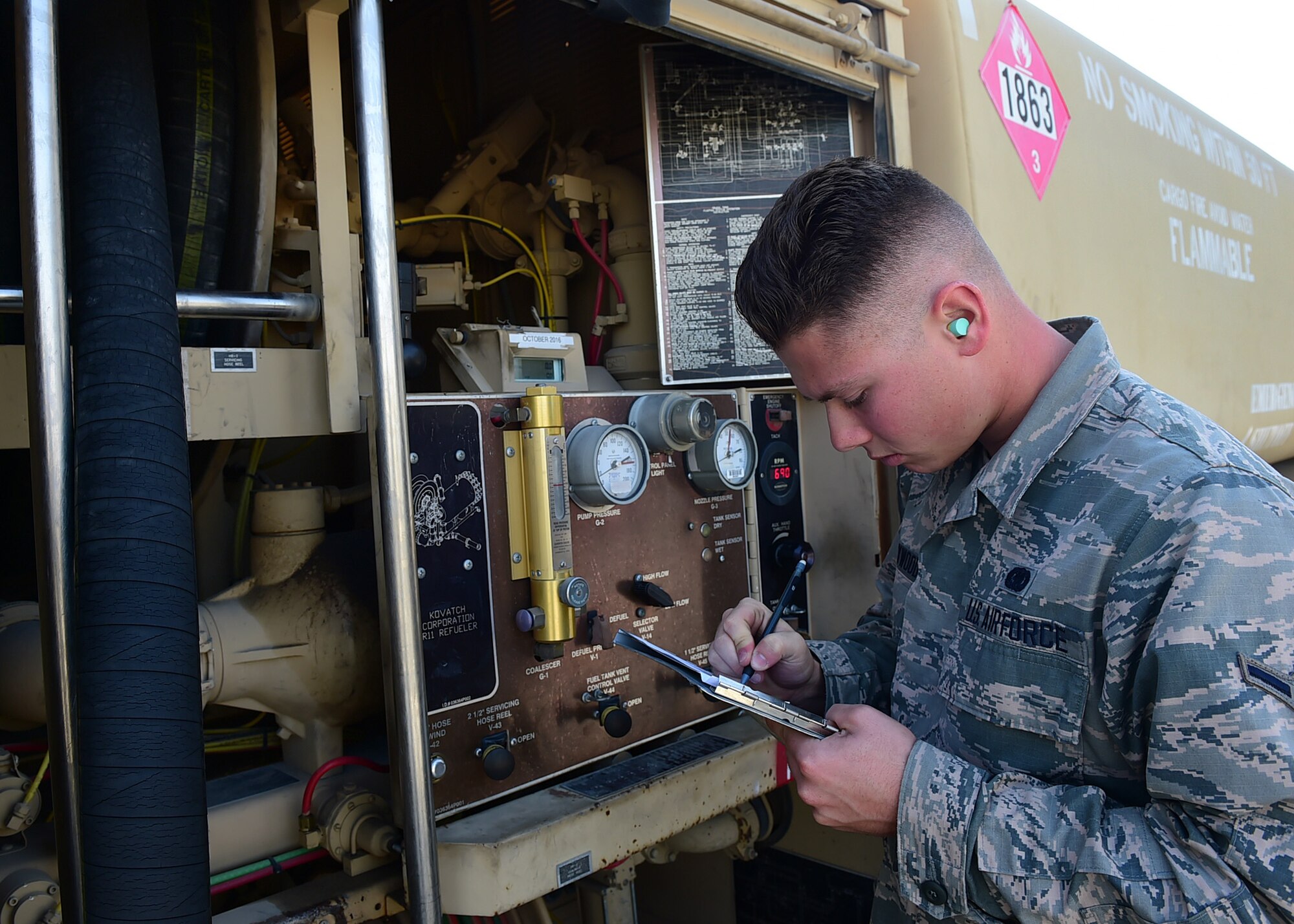 Airman Dalton Haywood, a 386th Expeditionary Logistics Readiness Squadron fuels distribution operator, completes an energy sales slip at an undisclosed location in Southwest Asia, Dec. 1, 2015. The fuels management flight processes more than 7000 transactions each year amounting to more than 21 million gallons of fuel. (U.S. Air Force photo by Staff Sgt. Jerilyn Quintanilla)