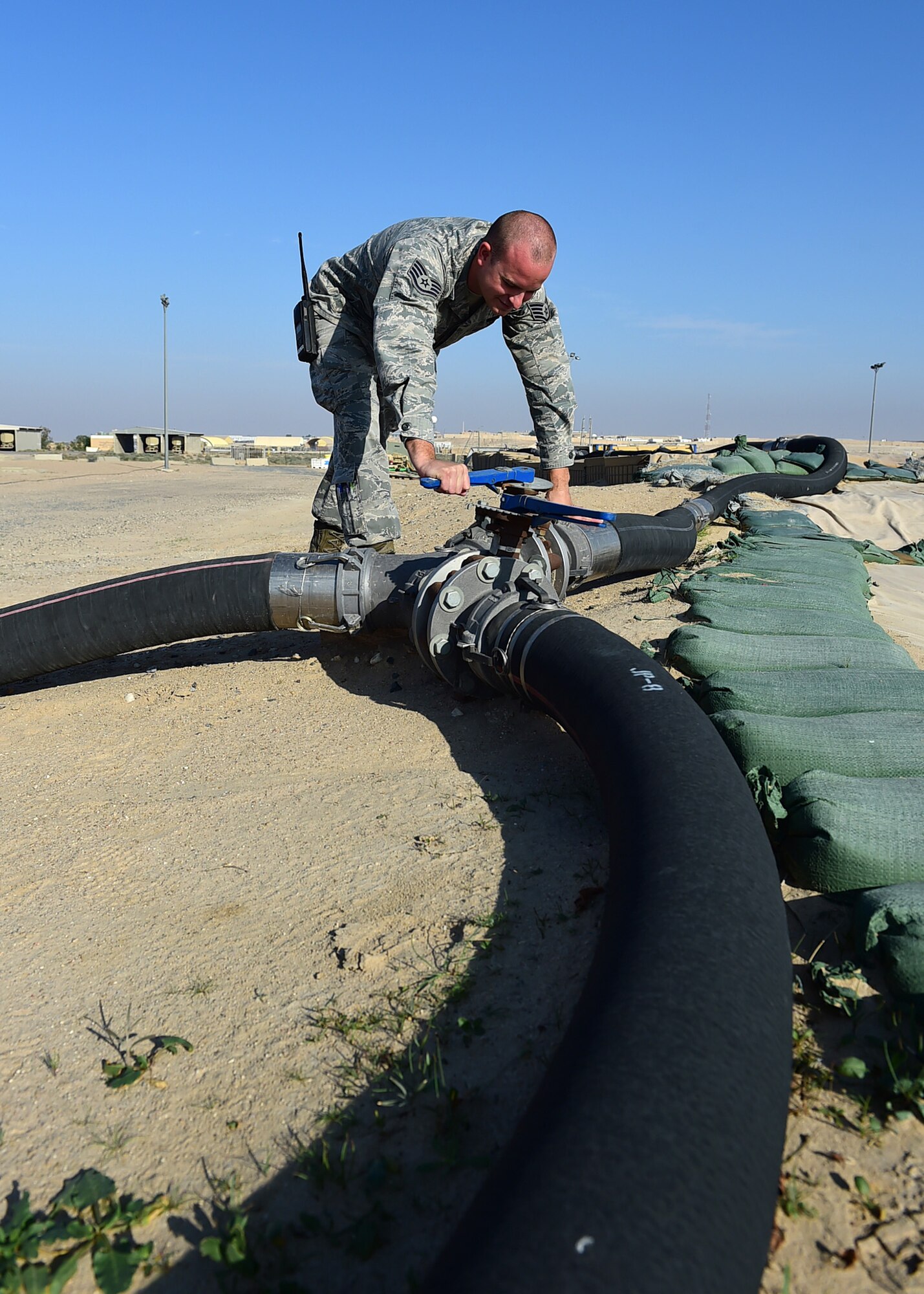 Staff Sgt. Russell Dupree, a 386th Expeditionary Logistics Readiness Squadron fuels systems craftsman, opens a fuel transfer valve at an undisclosed location in Southwest Asia, Dec. 1, 2015. The Petroleum, Oils and Lubricants flight is responsible for providing fuel to all aircraft, and ground equipment for U.S. and coalition forces on base in support of Operation INHERENT RESOLVE. (U.S. Air Force photo by Staff Sgt. Jerilyn Quintanilla)