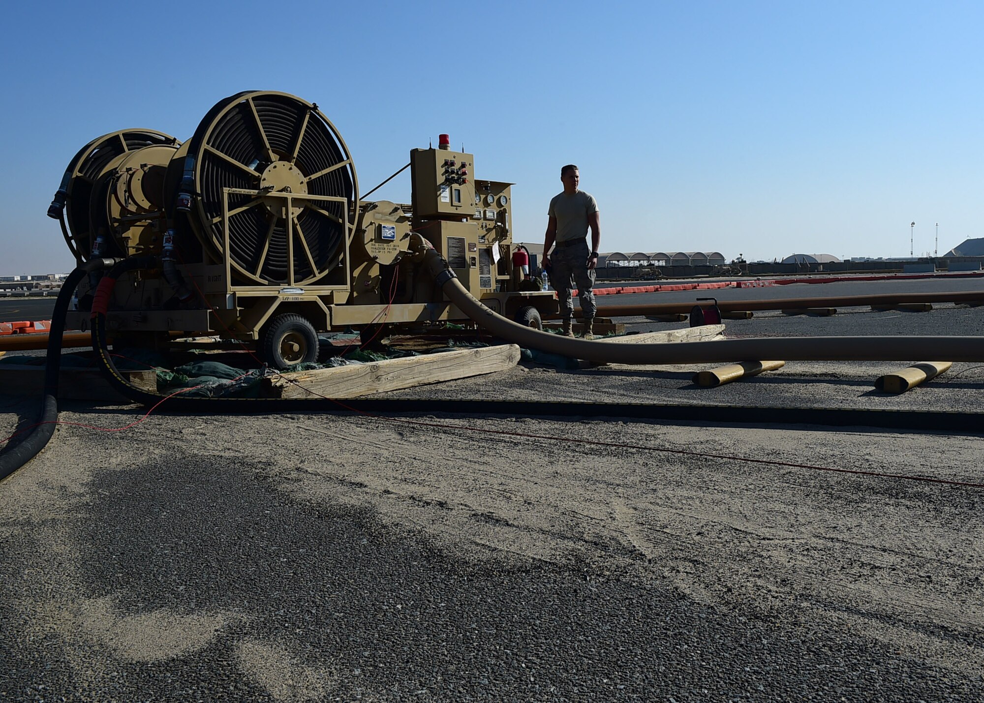 Airman Tyler Normandin, a 386th Expeditionary Logistics Readiness Squadron fuels distribution operator, operates an R-20 Multi-servicing platform providing fuel for an aircraft on the flightline at an undisclosed location in Southwest Asia, Dec. 1, 2015. The R-20 platform is connected via underground lines to fuel reserves enabling it to off-load thousands of gallons of fuel without the use of fuel trucks. (U.S. Air Force photo by Staff Sgt. Jerilyn Quintanilla)