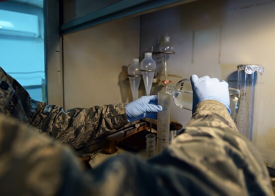 Senior Airman Nickolauss Guier, a 386th Expeditionary Logistics Readiness Squadron fuels laboratory technician, performs a Fuel System Icing Inhibitor test at an undisclosed location in Southwest Asia, Dec. 1, 2015. The FSII test is used to measure the concentration of FSII added or present in a jet fuel sample. (U.S. Air Force photo by Staff Sgt. Jerilyn Quintanilla)