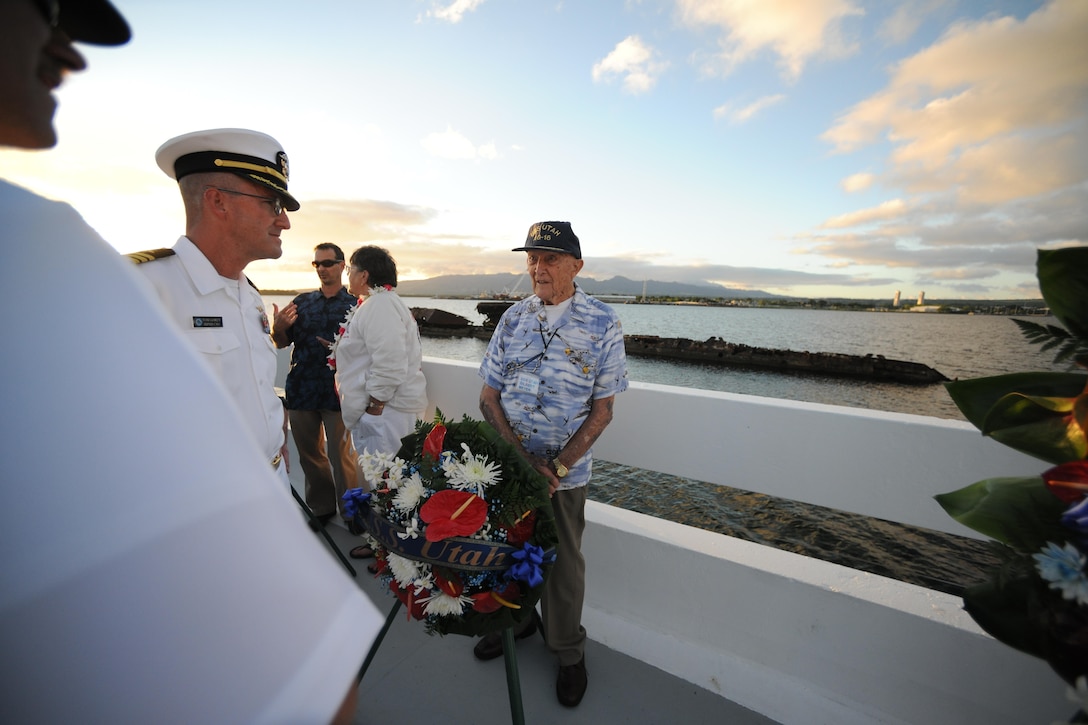 Gilbert Meyer, a Pearl Harbor survivor, speaks with service members at the USS Utah Memorial sunset tribute on Ford Island, Pearl Harbor, Dec. 6, 2015. Several events will take place leading up to the 74th anniversary of Pearl Harbor Day to pay tribute to the nation’s military while enlightening Americans about veterans and service. U.S. Navy photo by Petty Officer 1st Class Meranda Keller