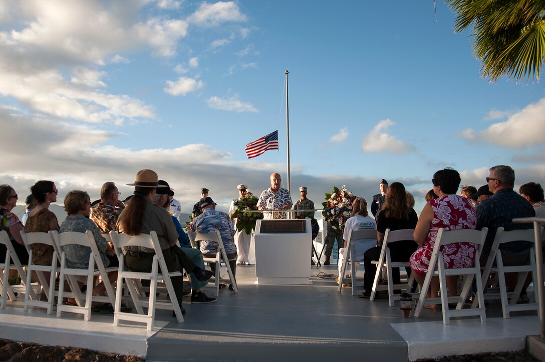 Retired Navy Master Chief Yeoman Jim Taylor, Pearl Harbor survivor liaison, delivers remarks during the USS Utah Memorial sunset tribute at Ford Island, Joint Base Pearl Harbor-Hickam, Hawaii, Dec. 6, 2015. U.S. Navy photo by Petty Officer 2nd Class Gabrielle Joyner