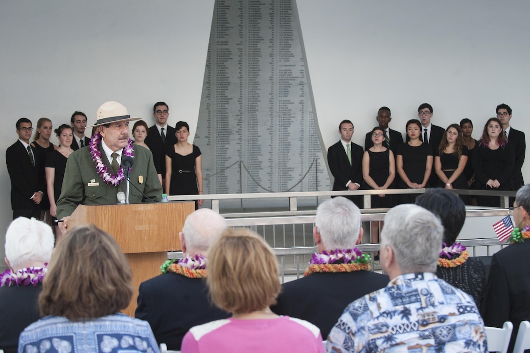 Daniel Martinez, USS Arizona Memorial chief historian, speaks at a Blackened Canteen ceremony as part of the 74th anniversary of Pearl Harbor Day Commemoration Anniversary at the USS Arizona Memorial, Hawaii, Dec. 6, 2015. The Blackened Canteen ceremony is a way for Americans and Japanese veterans, and observers, to extend a hand of continued friendship, peace and reconciliation by pouring bourbon whiskey as an offering to the fallen in the hallowed waters of Pearl Harbor. U.S. Air Force photo by Staff Sgt. Christopher Hubenthal