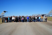 Spouses of Airmen from the 315th Airlift Wing, Joint Base Charleston, SC, pose along the runway at North Auxilary Airfield, North, SC after deplaning from three C-17 Globemaster III aircraft Saturday, Dec. 5. Spouses got the opportunity to witness several aerial demonstrations at North Auxilary Airfield prior to returning to JB Charleston. (U.S. Air Force photo by Staff Sgt. Bobby Pilch)