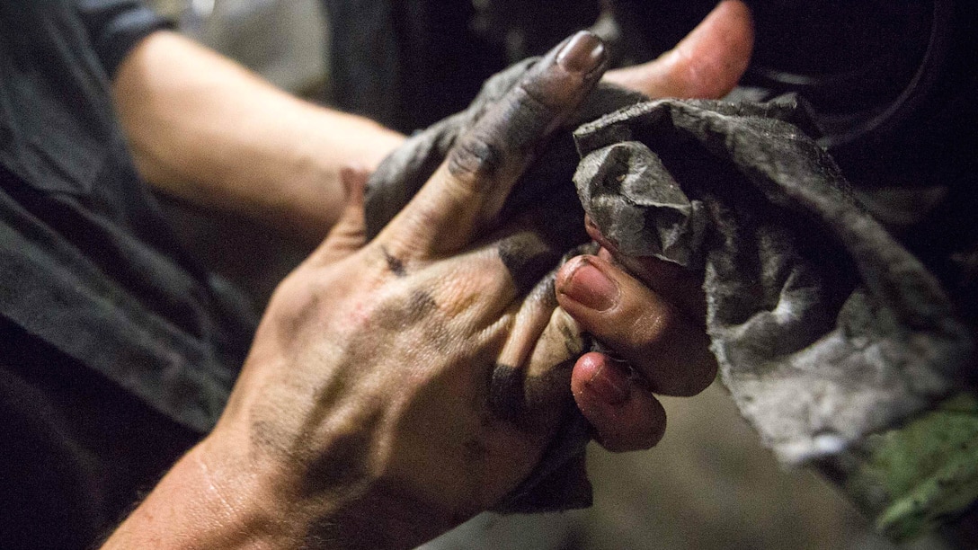 U.S. Marine Cpl. Dillon G. Gilmore, a light armored vehicle  repairman with Light Armored Reconnaissance Company, Battalion Landing Team 2/6, 26th Marine Expeditionary Unit (MEU), wipes off his hands after cleaning an LAV engine aboard the amphibious assault ship USS Kearsarge Dec. 4, 2015. Repairmen with the company serviced an LAV engine with an oil leak. The 26th MEU is embarked on the Kearsarge Amphibious Ready Group and is deployed to maintain regional security in the U.S. 5th Fleet area of operations. 