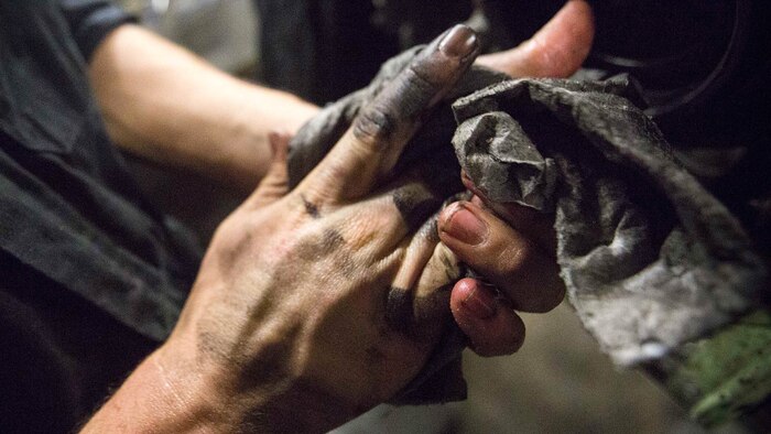 U.S. Marine Cpl. Dillon G. Gilmore, a light armored vehicle  repairman with Light Armored Reconnaissance Company, Battalion Landing Team 2/6, 26th Marine Expeditionary Unit (MEU), wipes off his hands after cleaning an LAV engine aboard the amphibious assault ship USS Kearsarge Dec. 4, 2015. Repairmen with the company serviced an LAV engine with an oil leak. The 26th MEU is embarked on the Kearsarge Amphibious Ready Group and is deployed to maintain regional security in the U.S. 5th Fleet area of operations. 