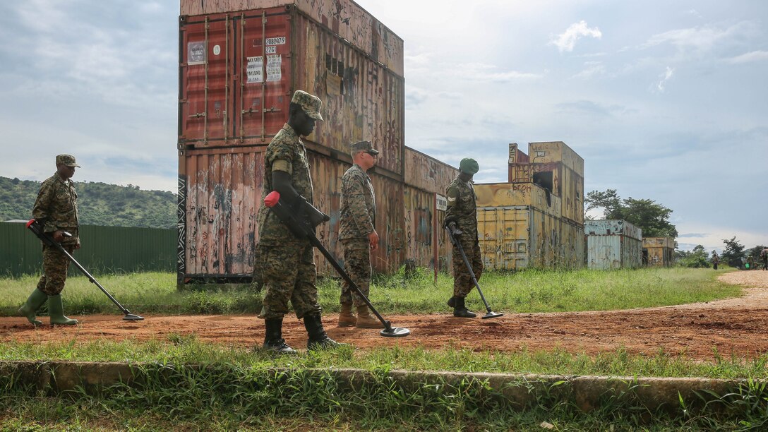 U.S. Marine Sgt. Sean O’Hair (middle), a combat engineer with Special-Purpose Marine Air-Ground Task Force Crisis Response-Africa, leads Uganda People’s Defense Force soldiers through a notional improvised explosive device lane during IED awareness training at Camp Singo, Uganda, Nov. 3, 2015. All UPDF soldiers went through IED awareness training before they split into their military occupational specialties-specific training. This type of training is important for all the soldiers as one of the greatest threats in the African Union Mission in Somalia are IEDs. 
