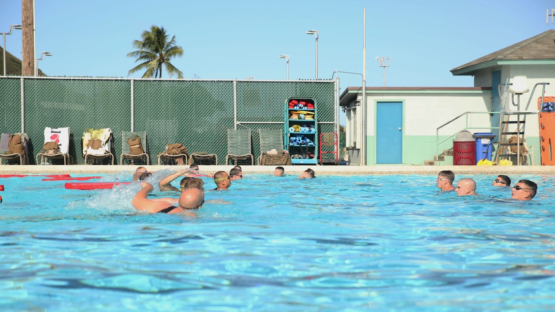 Students in Marine Corps Instructor Course of Water Survival practice rescuing a victim from drowning at the base pool aboard Marine Corps Base Hawaii, Dec. 1, 2015. MCICWS is a course for noncommissioned officers and higher to become water survival instructors, whose purpose is to make sure Marines are safe during swim qualification. 