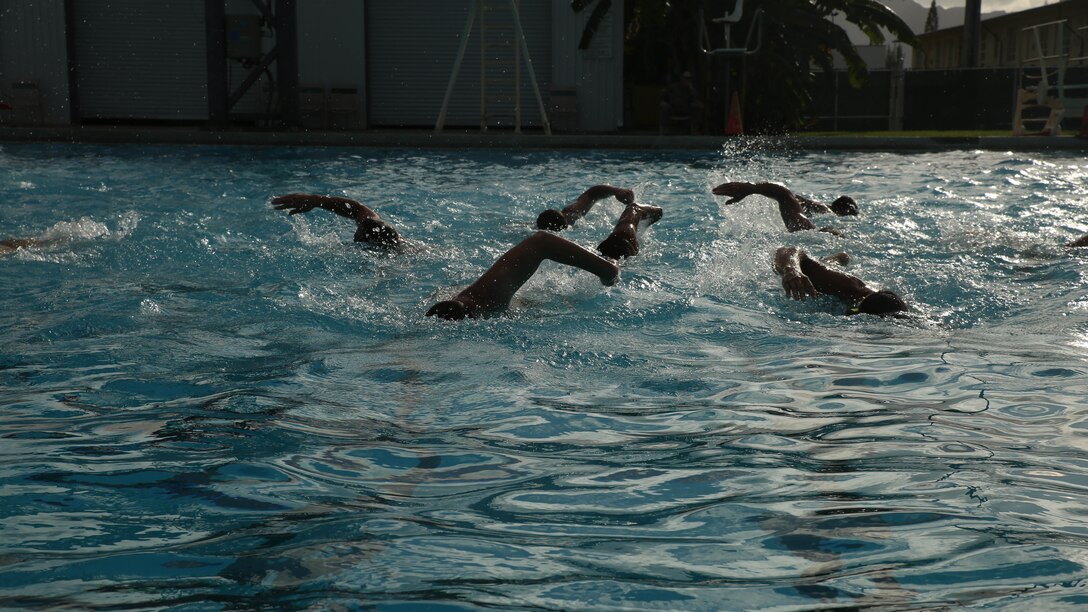 Students in the Marine Corps Instructor Course of Water Survival swim across the pool as they conduct water physical training at the base pool aboard Marine Corps Base Hawaii, Dec. 1, 2015. MCICWS is a course for noncommissioned officers and higher to become water survival instructors, whose purpose is to make sure Marines are safe during basic swim qualification. 