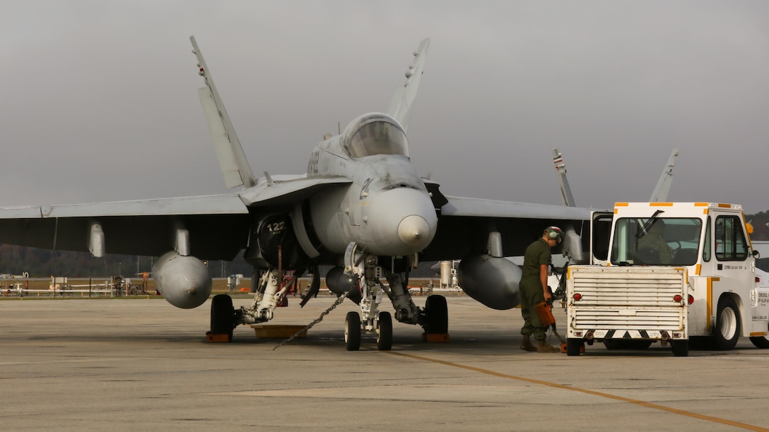 A Marine performs maintenance on an F/A-18C Hornet on the flight line Dec. 1 at Marine Corps Air Station Beaufort, S.C. after returning from Integrated Training Exercise held at Marine Corps Air Ground Combat Center, Twentynine Palms, Calif., from Oct. 16- Nov. 20. Marine Fighter Attack Squadron 122 returned to the air station after a 38-day integrated training exercise. VMFA-122 conducted the training exercise to prepare for an upcoming deployment in early 2016. The jet and Marine are with VMFA-122, Marine Aircraft Group 31.