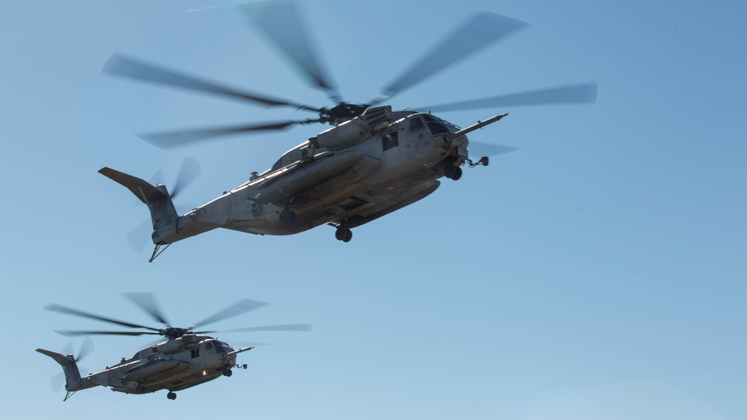 Two CH-53E Super Stallions fly over a landing zone  during section Confined Area Landings board Marine Corps Base Camp Pendleton, Calif., Dec. 2, 2015. Marines with HMH-361 conducted section Confined Area Landings and Field Carrier Landing Practices to fulfill training requirements for landing aboard a Navy ship.