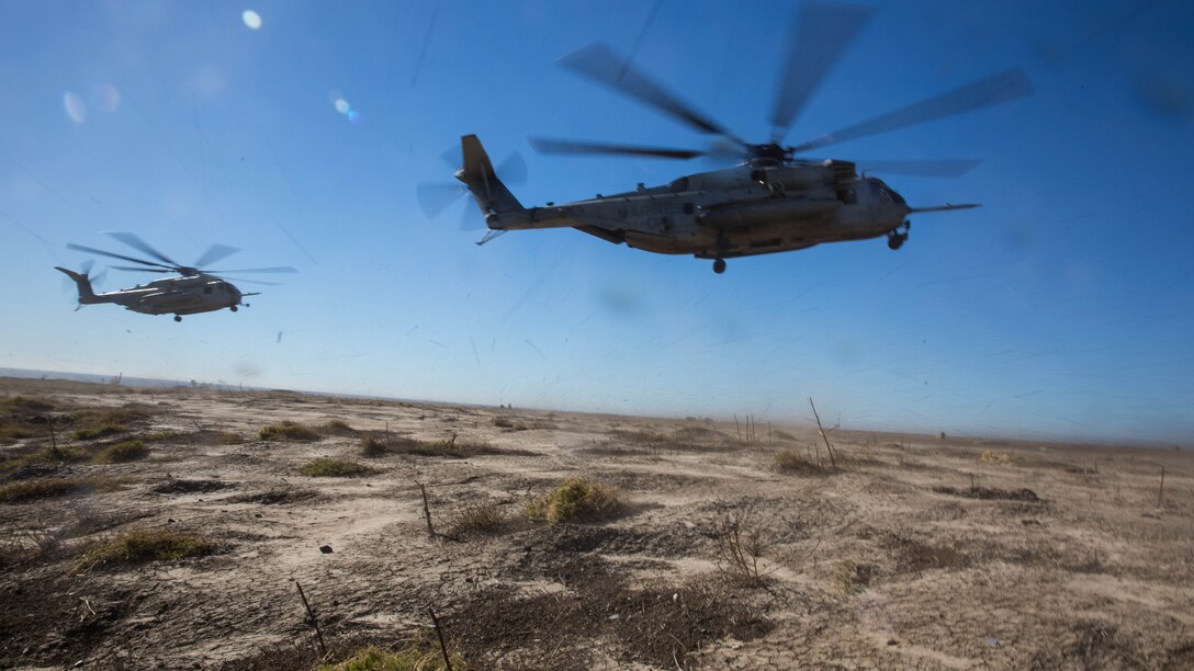 Two CH-53E Super Stallions prepare to land during section Confined Area Landings board Marine Corps Base Camp Pendleton, Calif., Dec. 2, 2015. Marines with HMH-361 conducted section Confined Area Landings and Field Carrier Landing Practices to fulfill training requirements for landing aboard a Navy ship. 