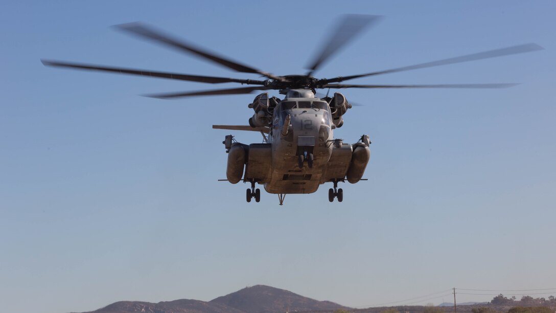 A CH-53E Super Stallion with Marine Heavy Helicopter Squadron 361 hovers over a landing pad during Field Carrier Landing Practices aboard Marine Corps Air Station Miramar, Calif., Dec. 2, 2015. Marines with HMH-361 conducted section Confined Area Landings and Field Carrier Landing Practices to fulfill training requirements for landing aboard a Navy ship. 