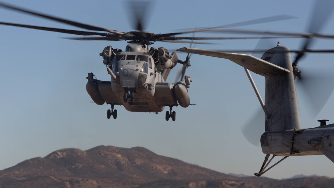 A CH-53E Super Stallion with Marine Heavy Helicopter Squadron 361 hovers over a landing pad during Field Carrier Landing Practices aboard Marine Corps Air Station Miramar, Calif., Dec. 2, 2015. Marines with HMH-361 conducted section Confined Area Landings and Field Carrier Landing Practices to fulfill training requirements for landing aboard a Navy ship. 