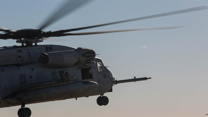 A CH-53E Super Stallion with Marine Heavy Helicopter Squadron 361 hovers over a landing pad during Field Carrier Landing Practices aboard Marine Corps Air Station Miramar, Calif., Dec. 2, 2015. Marines with HMH-361 conducted section Confined Area Landings and Field Carrier Landing Practices to fulfill training requirements for landing aboard a Navy ship. 