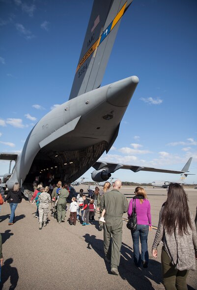 315th Operations Group members and their families board a C-17 Globemaster III Saturday after Santa & Mrs. Claus flew in from the North Pole. (U.S. Air Force photo by 2nd Lt. Rashard Coaxum)