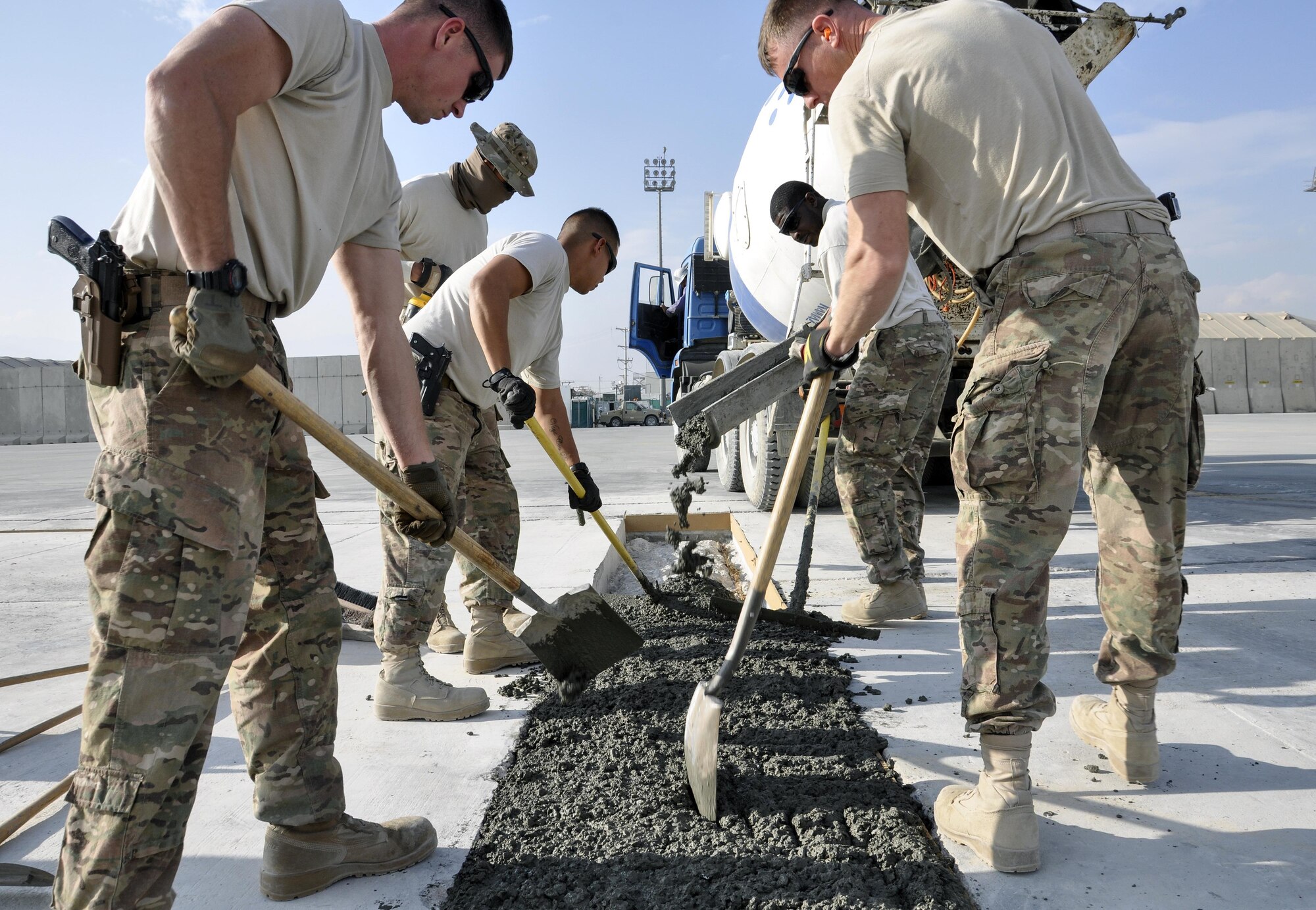 Airman 1st Class Alex Gromley and Staff Sgt. Ranson Holt, both from the 455th Expeditionary Civil Engineer Squadron, use a machine that flattens down cement in order to repair a section of the flightline at Bagram Airfield, Afghanistan, Dec. 7, 2015. Airfield integrity concerns are reviewed twice a month by Airfield Management and 455th ECES. Once repairs are completed, these areas of the flightline should not require maintenance for up to 10 years.  (U.S. Air Force photo by Tech. Sgt. Nicholas Rau/Released)