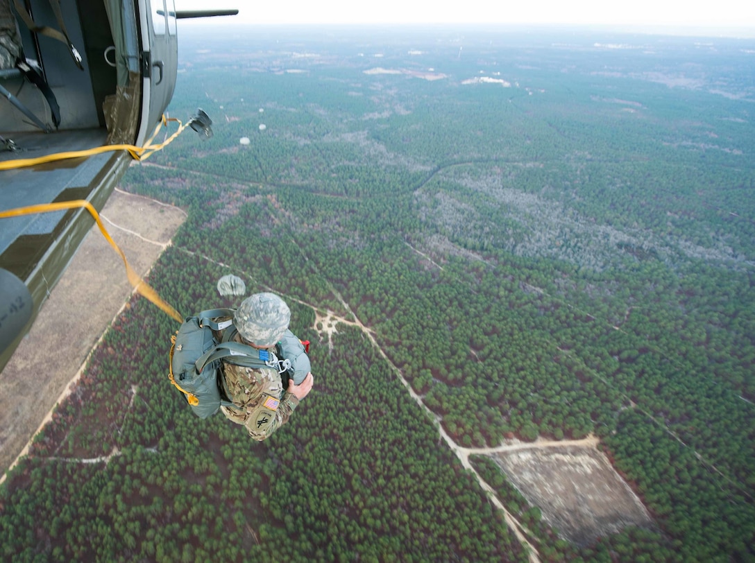A paratrooper jumps from a UH-60 Black Hawk helicopter during an airborne operation for Operation Toy Drop over Nijmegan drop zone, Ft. Bragg, N.C., Dec. 3, 2015. U.S. Army photo by Staff Sgt. Alex Manne