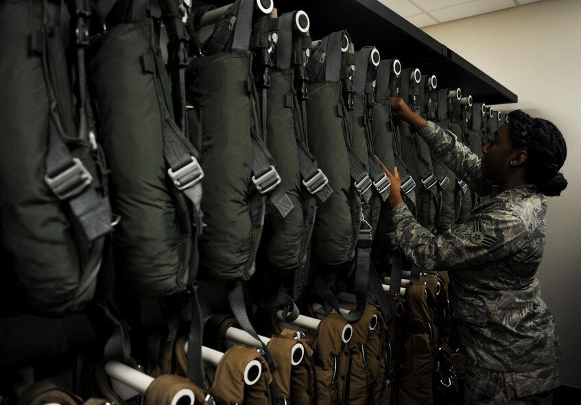 Senior Airman Kasie Whitfield, an aircrew flight equipment journeyman with the 4th Special Operations Squadron, checks expiration dates on BA-22 parachutes at Hurlburt Field, Fla., Dec. 4, 2015. Parachutes are inspected every 30 days to ensure the safety of aircrew members. (U.S. Air Force phot by Senior Airman Krystal M. Garrett)