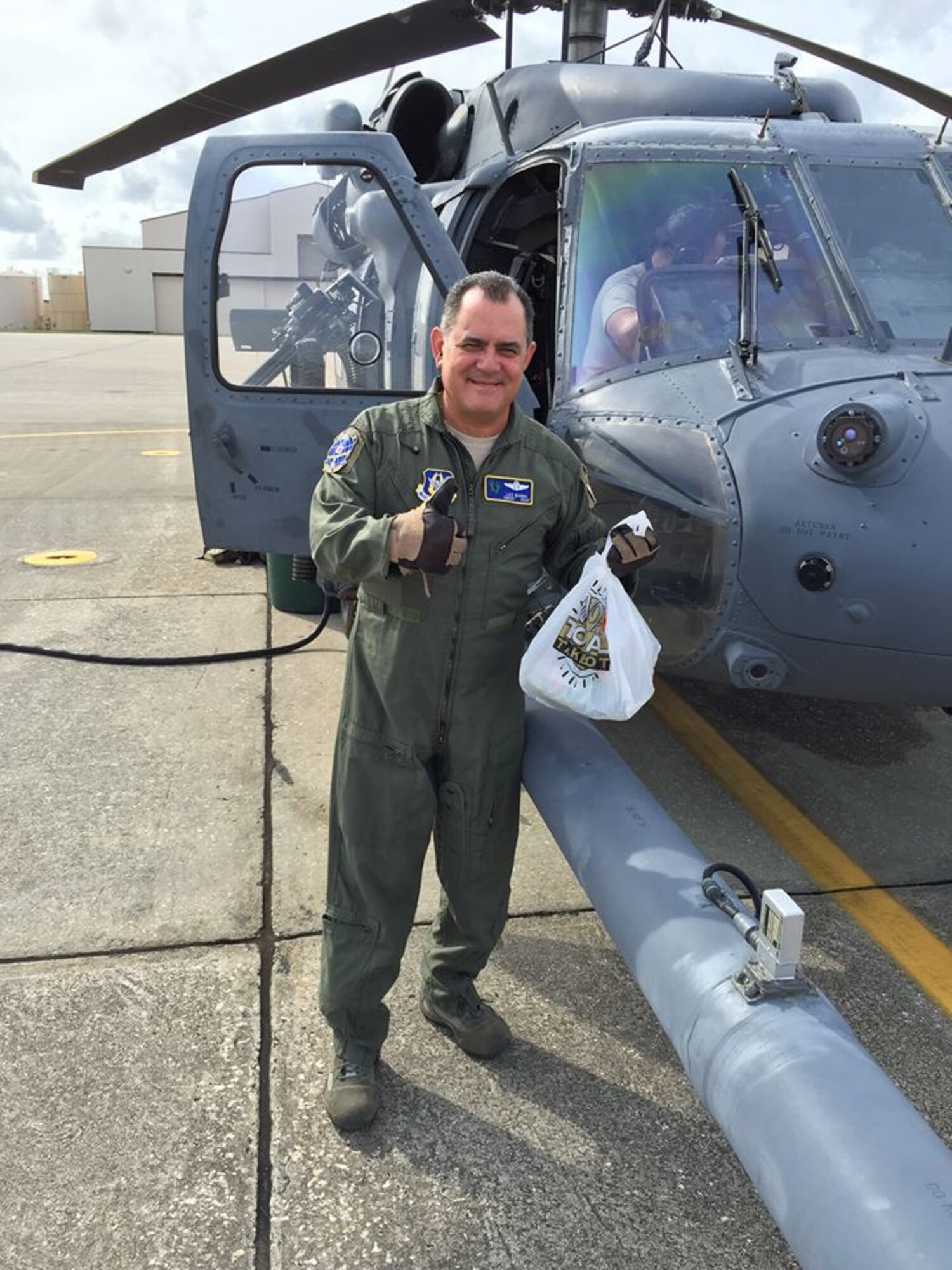 Chief Master Sgt. Lazaro Ibarra, 301st Rescue Squadron special mission aviator here, gives a thumbs up and as he prepares to board an HH-60G Pave Hawk helicopter with his last official box lunch. Ibarra’s fini-flight here, Dec. 2 marks end of the chief’s 35-year career. (Courtesy photo)
