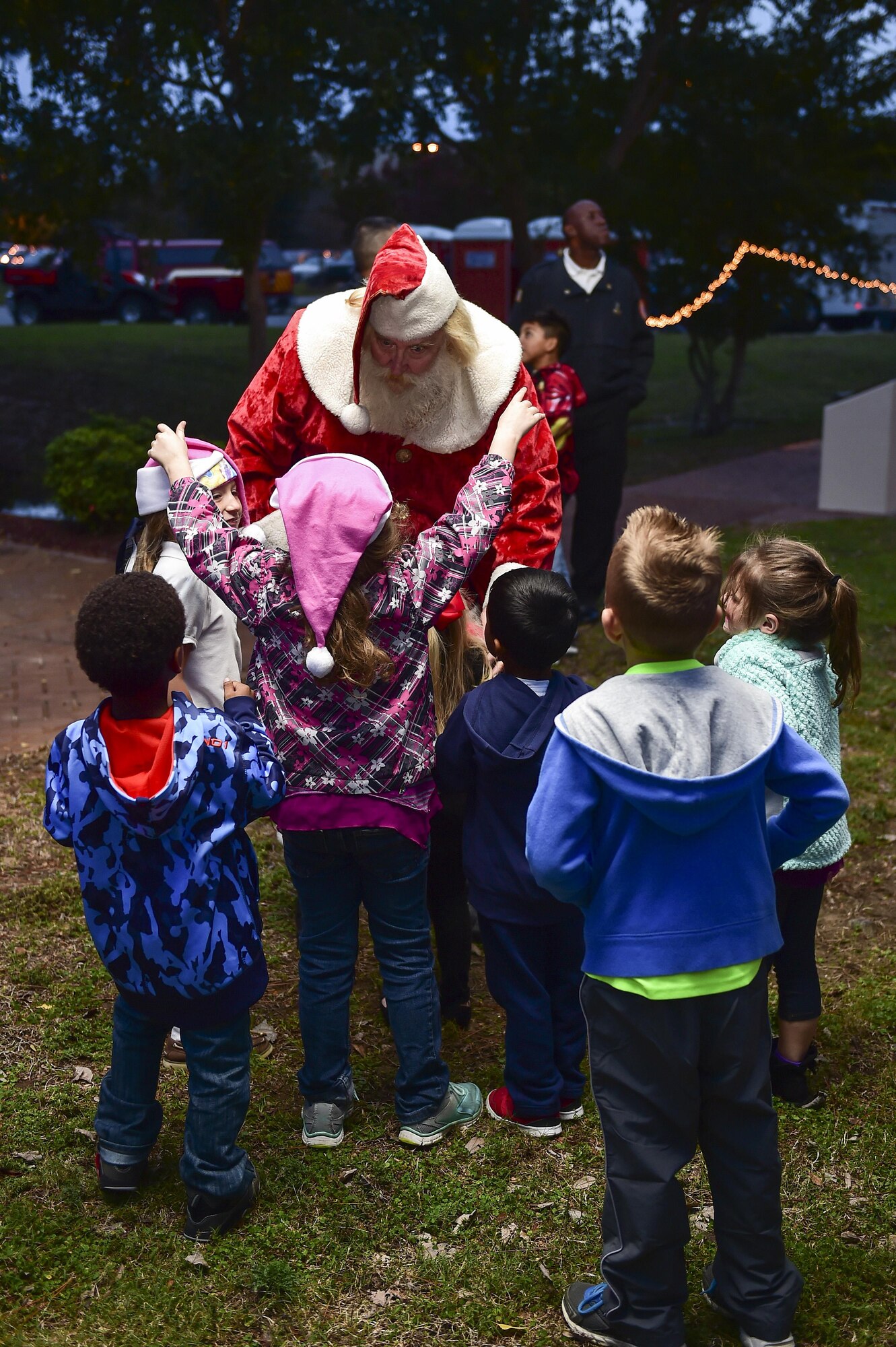Children greet Santa Claus during the annual Christmas tree lighting ceremony at Hurlburt Field, Fla., Dec 2, 2015. The winter wonderland celebration included pictures with Santa Claus, face painting, cookie decorating and much more. (U.S. Air Force photo by Senior Airman Jeff Parkinson)