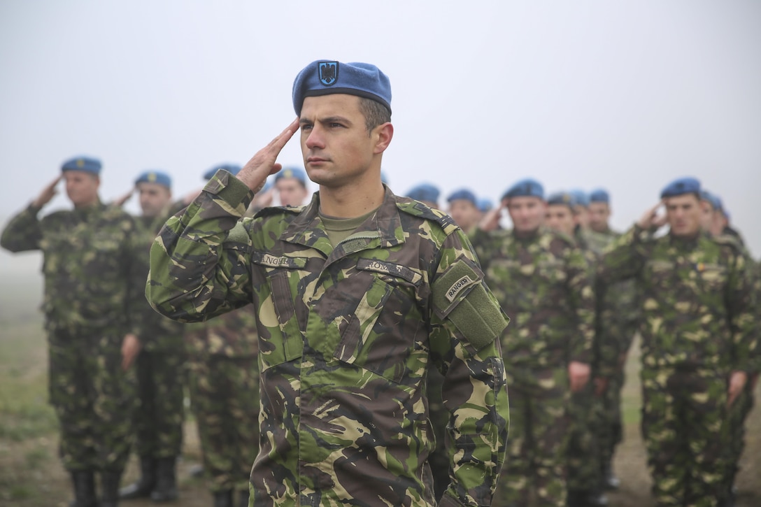 Romanian soldiers render honors to commemorate the 74th anniversary of the attack on Pearl Harbor during a ceremony on Mihail Kogalniceanu Air Base, Romania, Dec. 7, 2015. The ceremony, made up of U.S. Marines, U.S. Army and Romanian soldiers, recognized lives lost during the 1941 military strike which led to the United States’ entry into World War II. U.S. Marine Corps photo by Cpl. Kaitlyn V. Klein